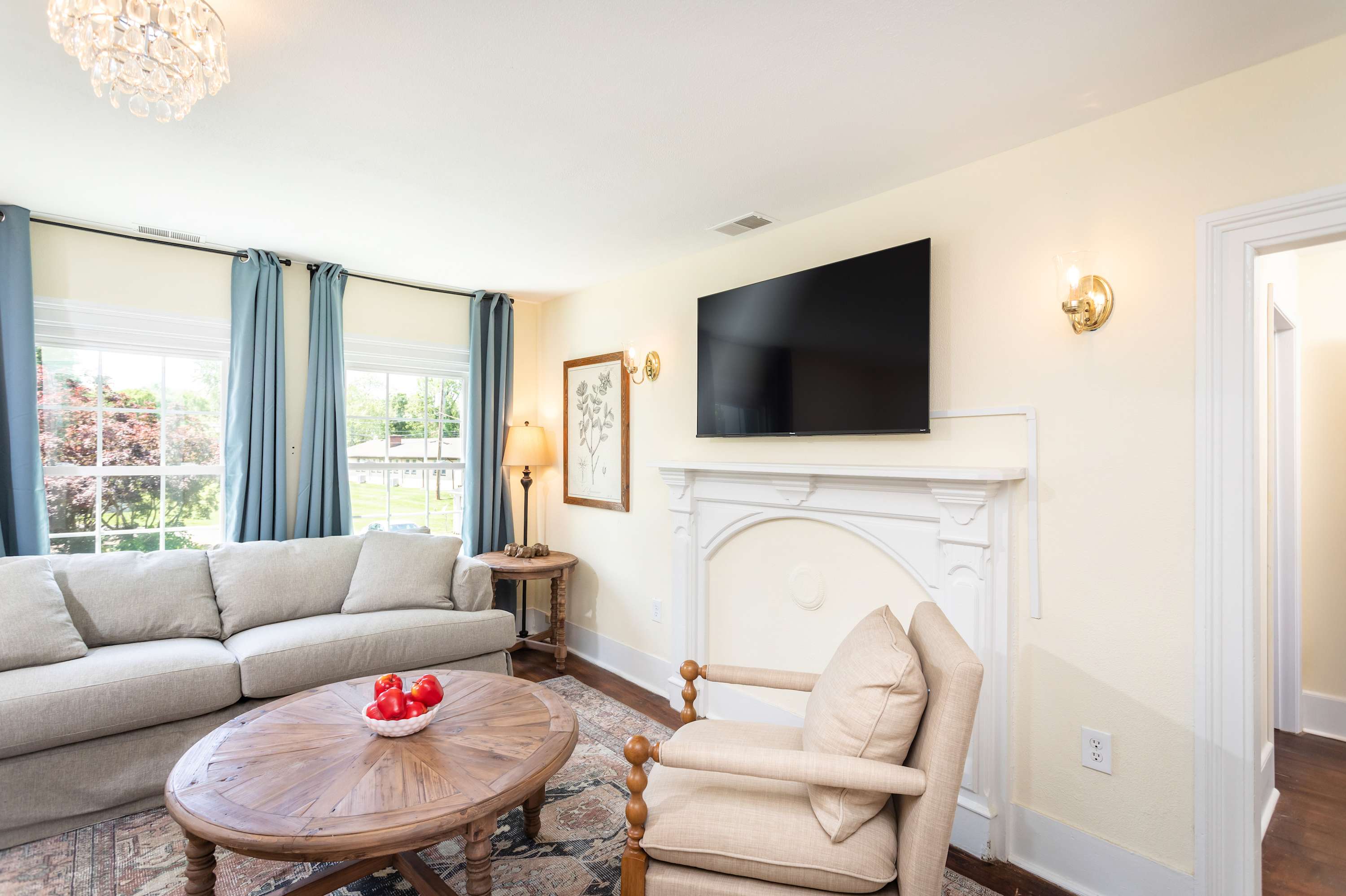 Relax in this bright living room featuring a large flat-screen TV and comfortable seating.
