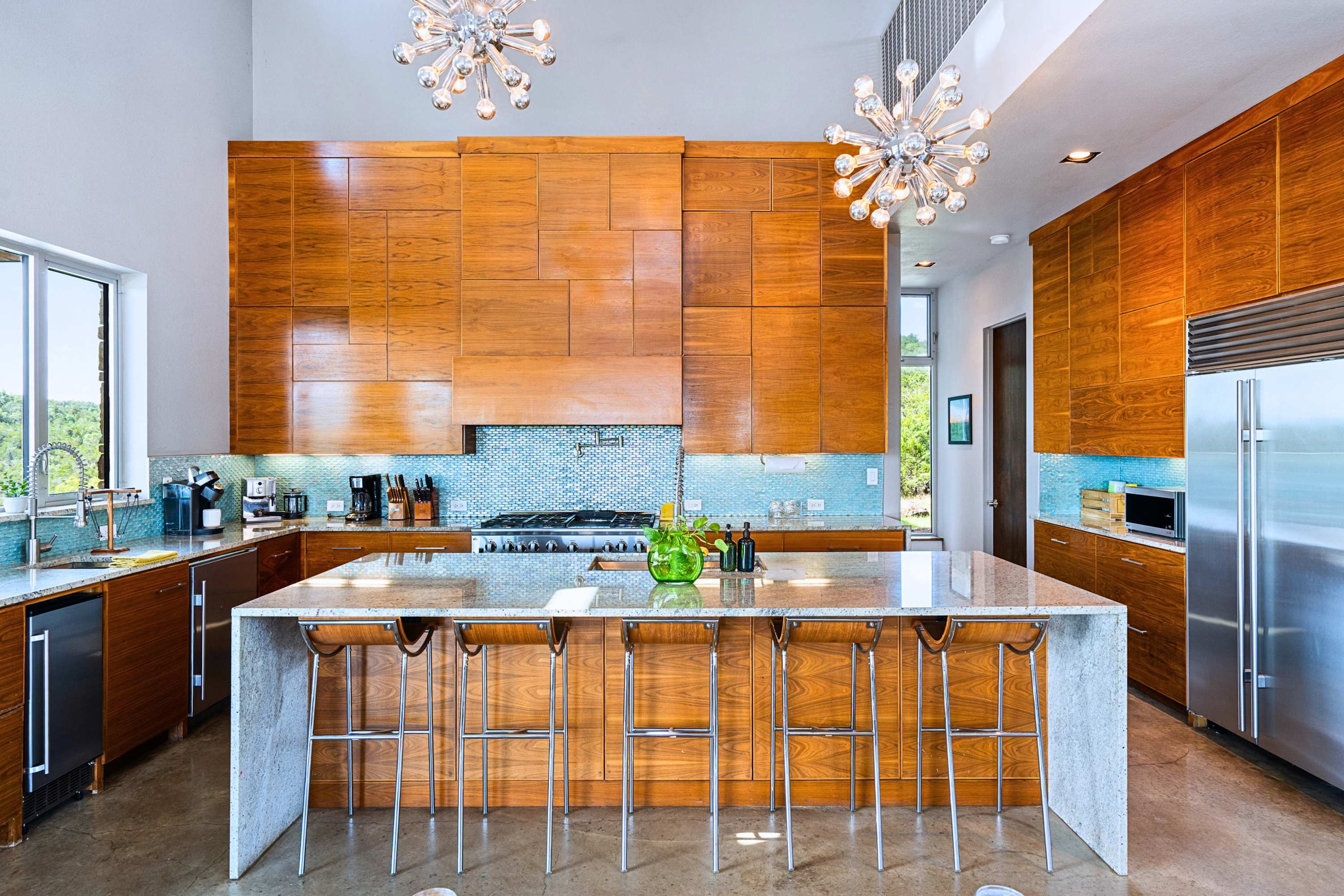 Main: Massive granite island with premium bar seating for morning coffee and chats.