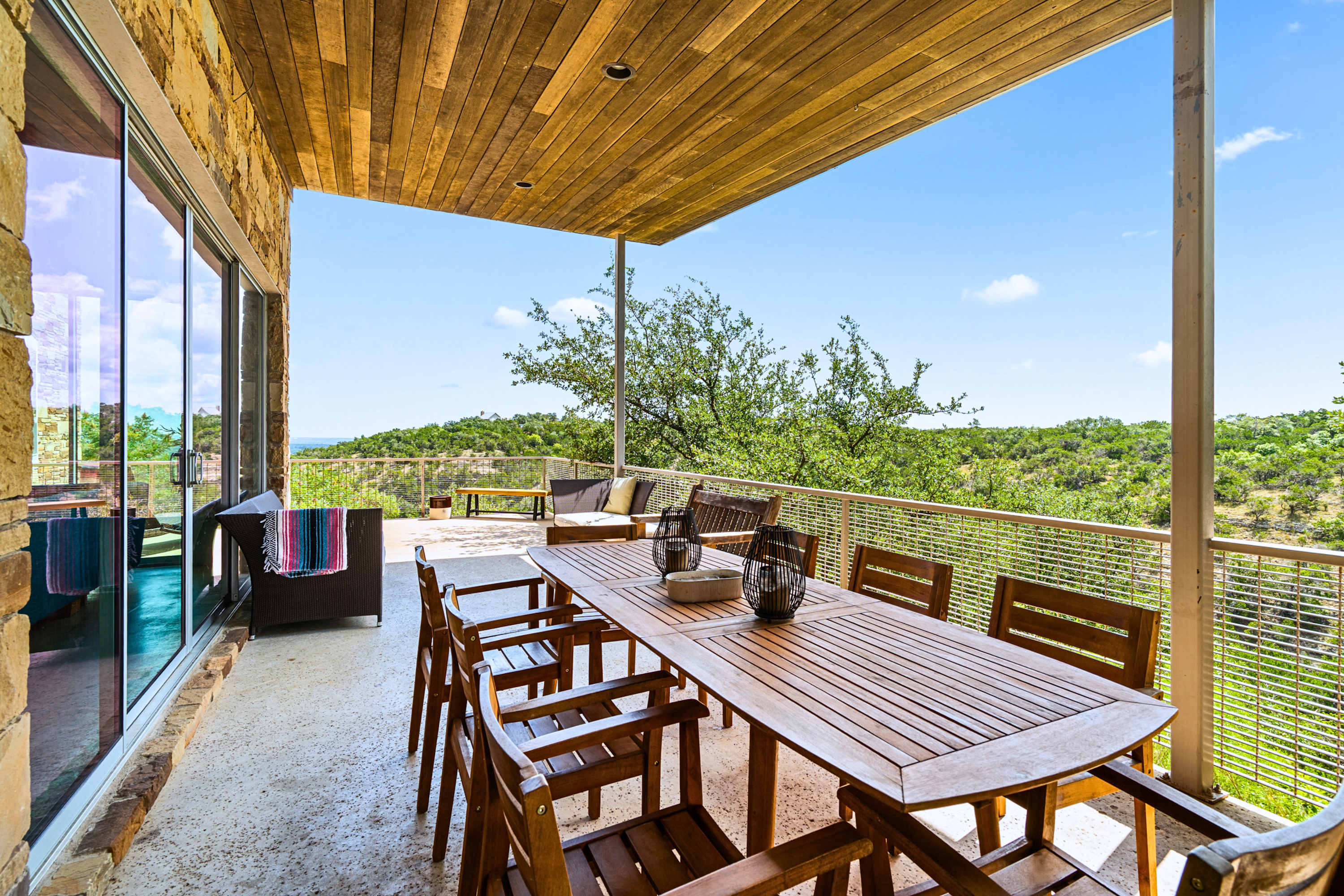 Main: Enjoy breezy al fresco meals at the shaded outdoor table overlooking the canopy.