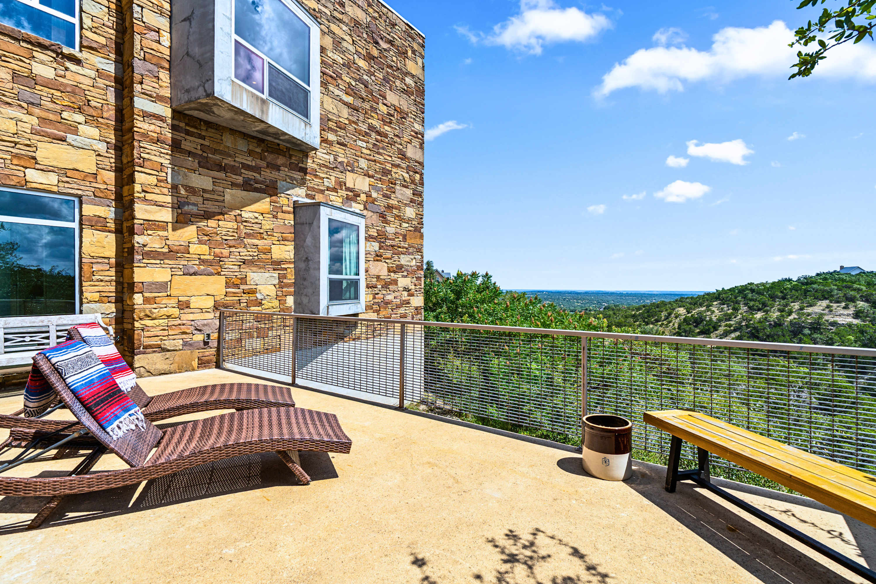 Main: Soak up the Texas sun on premium loungers with breathtaking panoramic hillside views.
