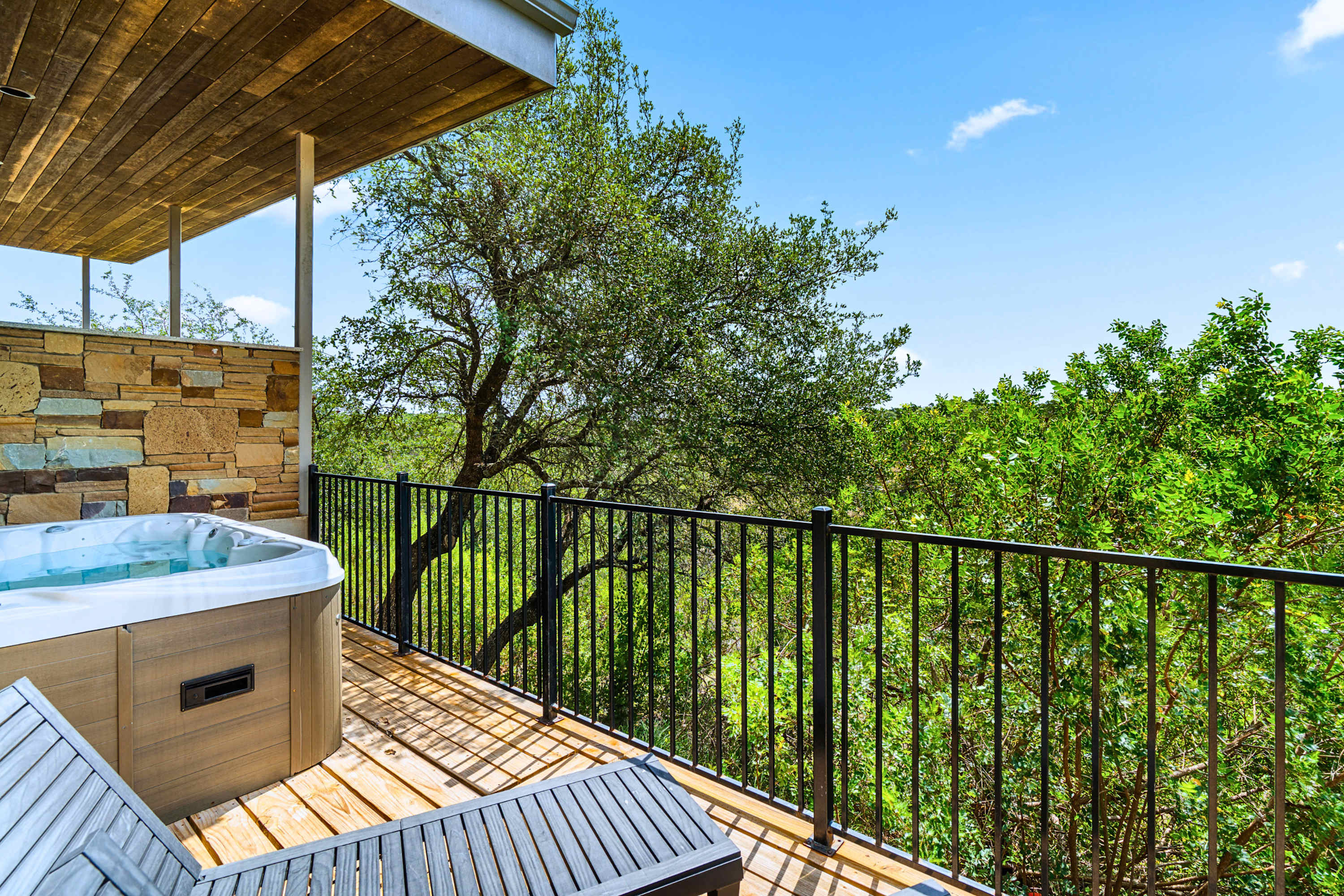 Main: Melt all your worries away in the secluded outdoor hot tub, wrapped in peaceful nature.