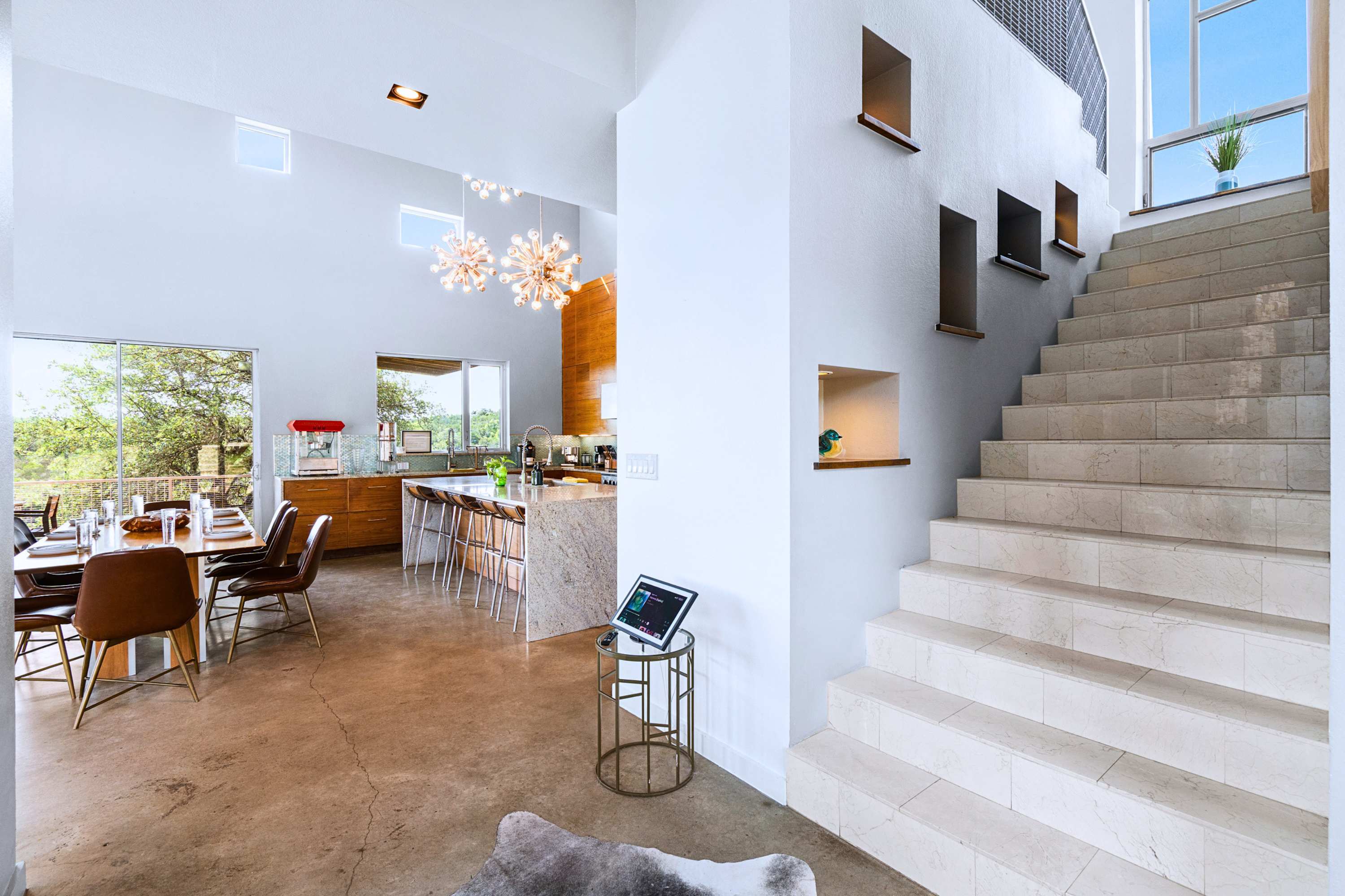 Main: Architectural perfection with grand stairs opening into sunlit gathering spaces.