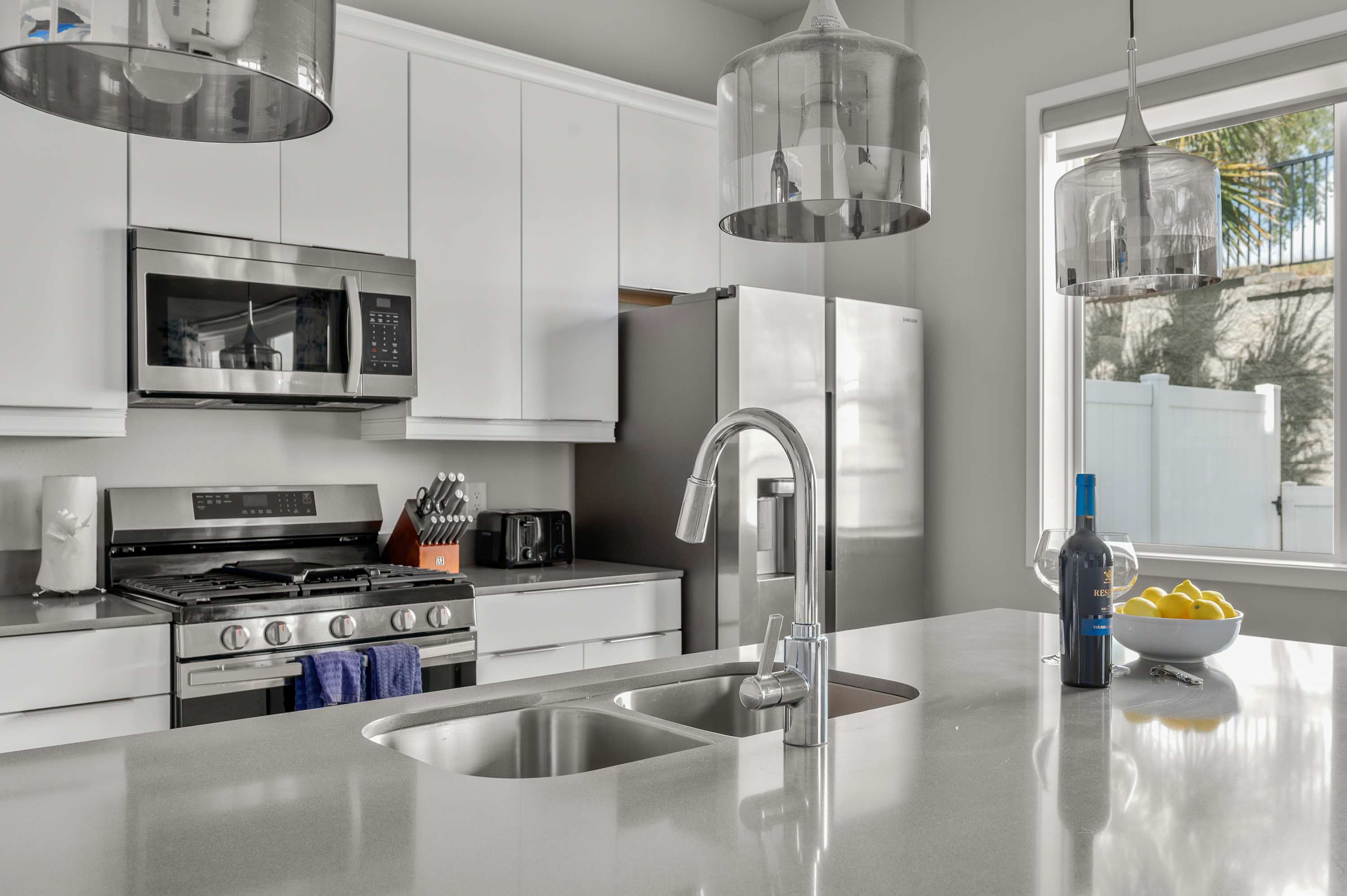 Modern kitchen with stainless steel appliances and a large island countertop.