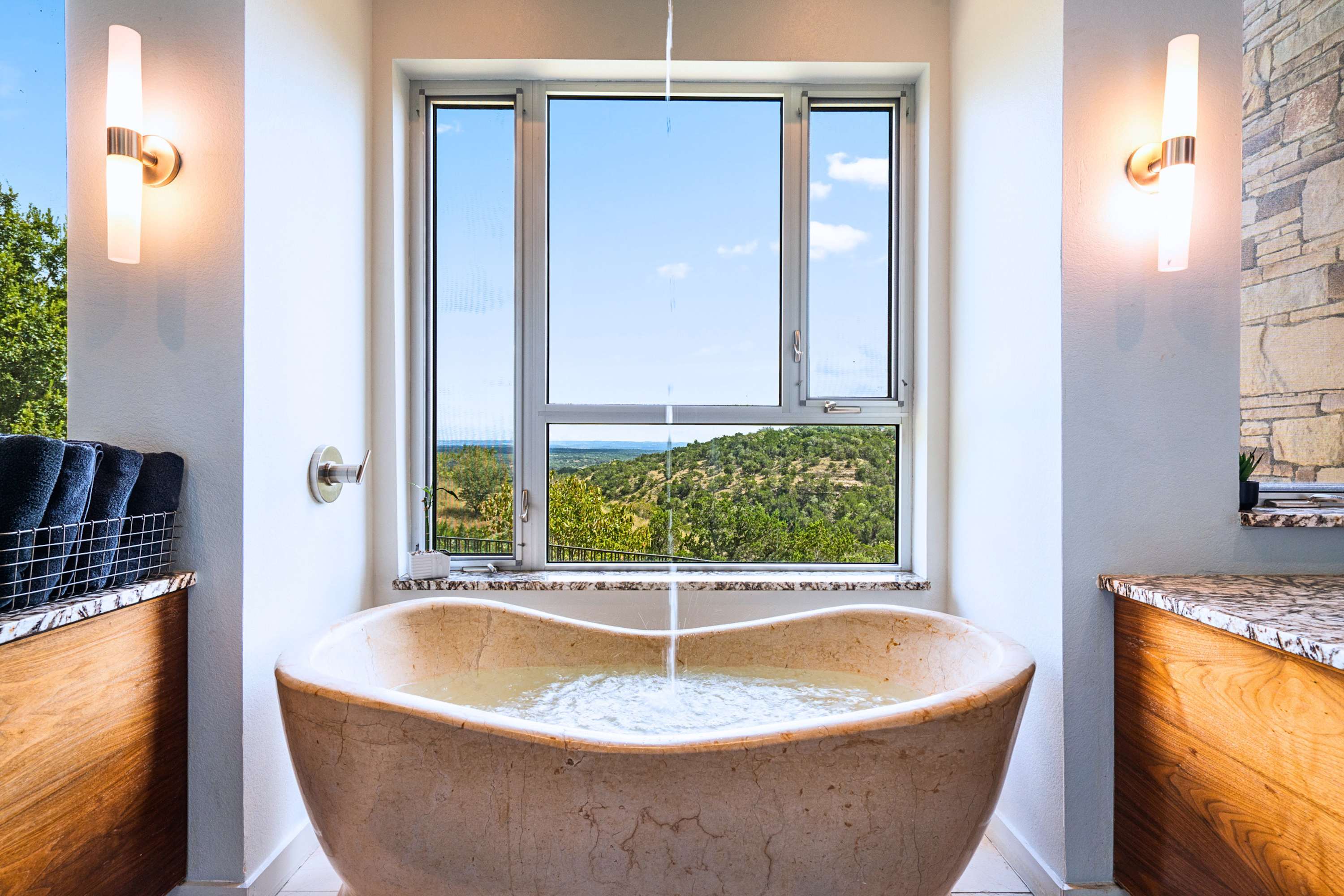 Main: Melt your worries away in a deep soaking tub framed by scenic nature vistas.