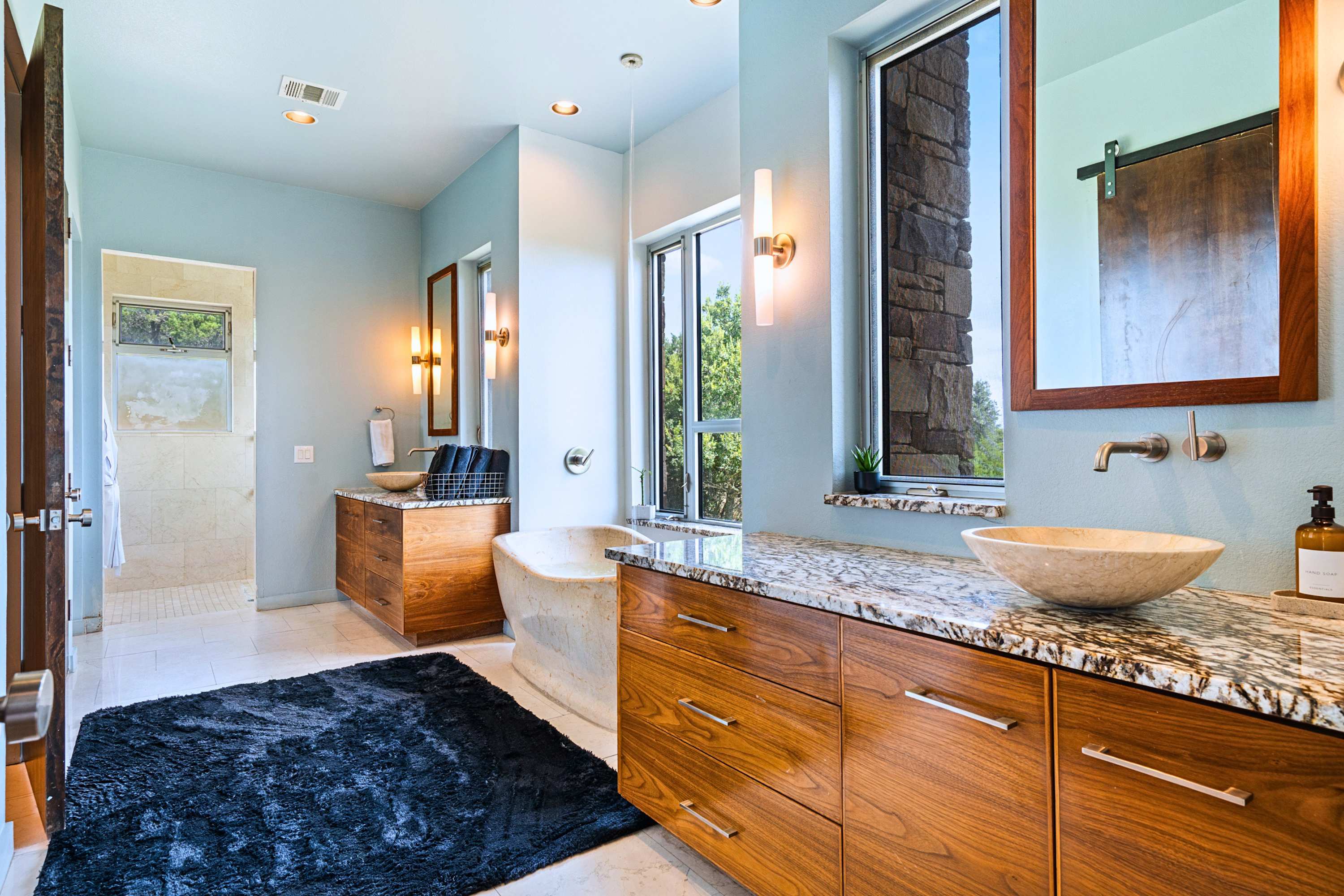 Main: Modern stone and rich wood finishes combine for a true spa-like atmosphere.