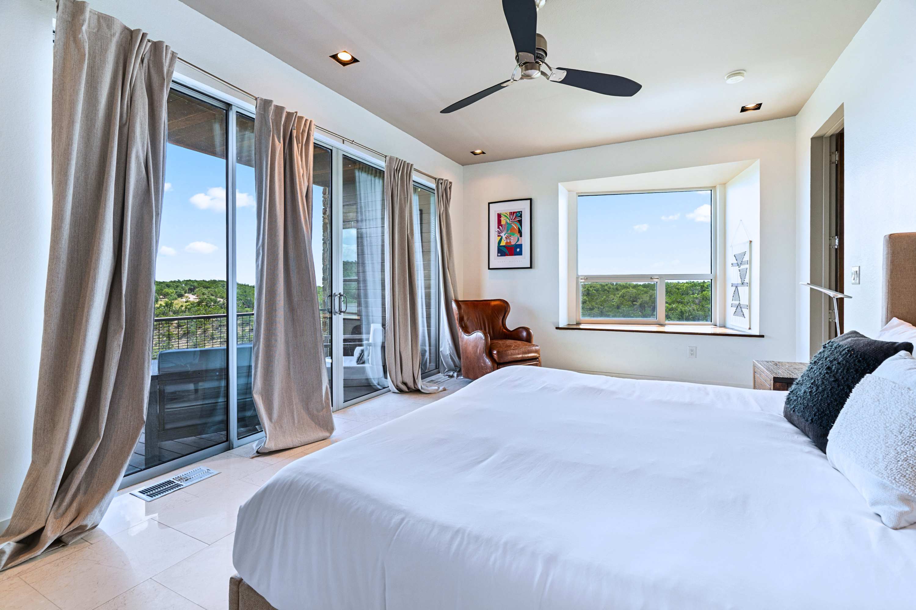 Main: Sprawl out and enjoy wall-to-wall windows overlooking the rolling green hills.