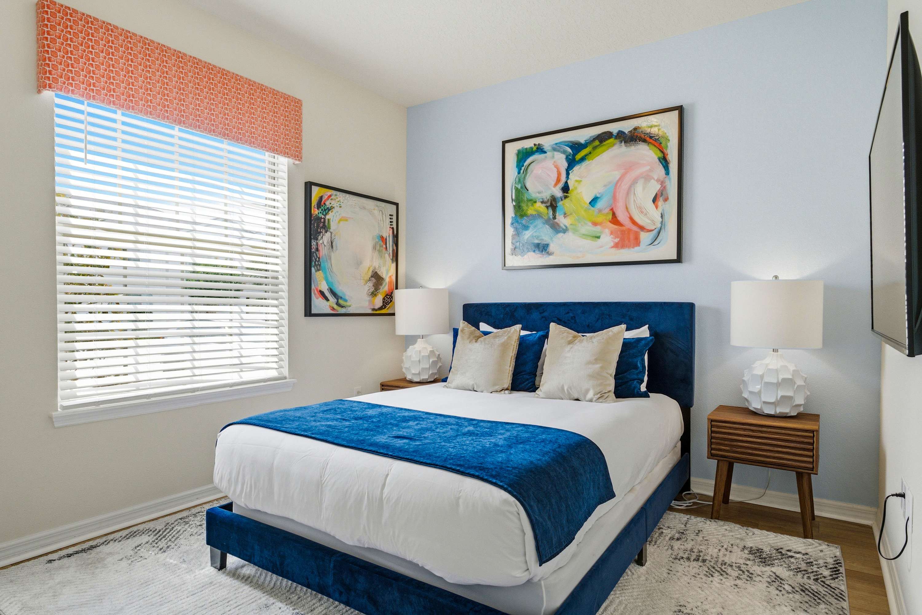 This cozy queen bedroom includes a smart TV & closet storage