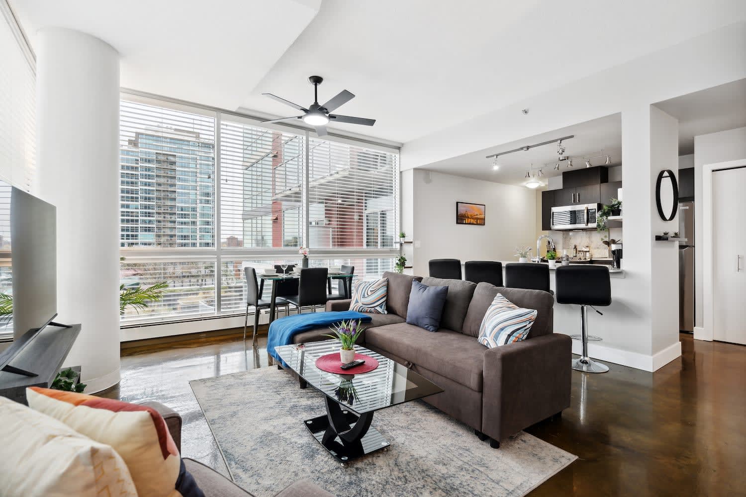 Modern Open-Concept Living With Kitchen, Dining, And Smart TV Setup