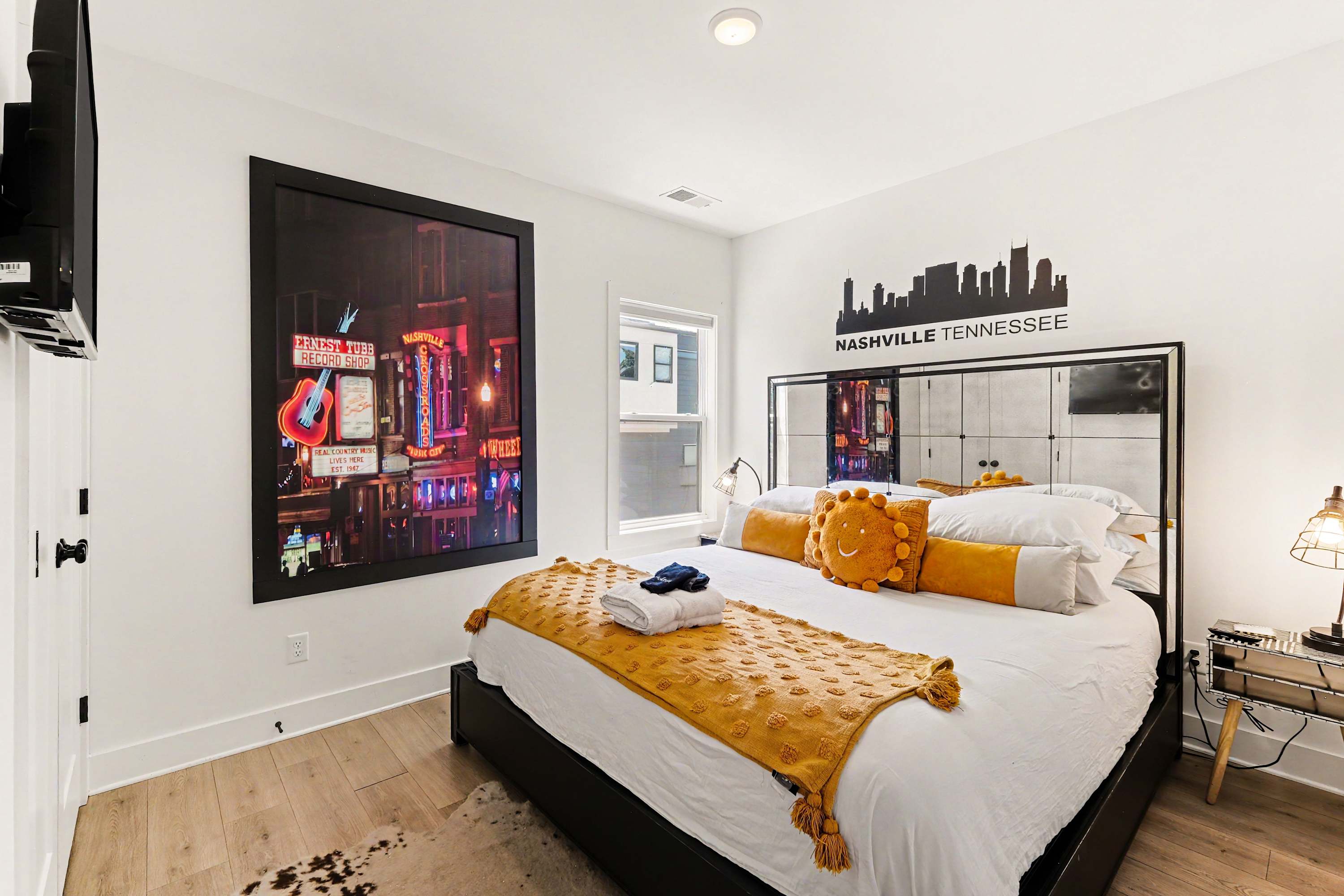 This stylish second floor bedroom offers guests a cozy king bed & Smart TV