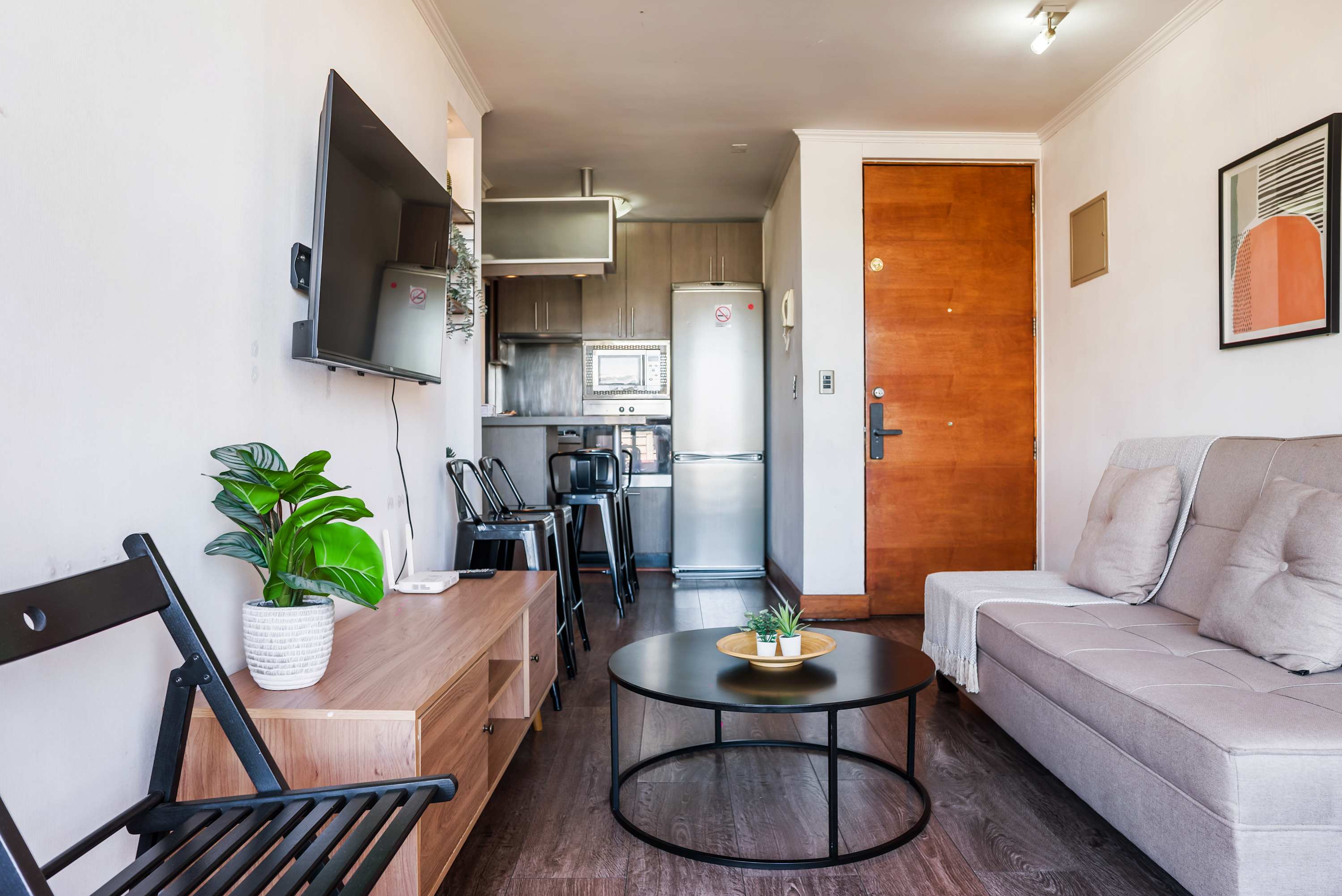 Relax in this cozy living area with modern amenities and a sleek kitchenette, perfect for unwinding after a day in the city.