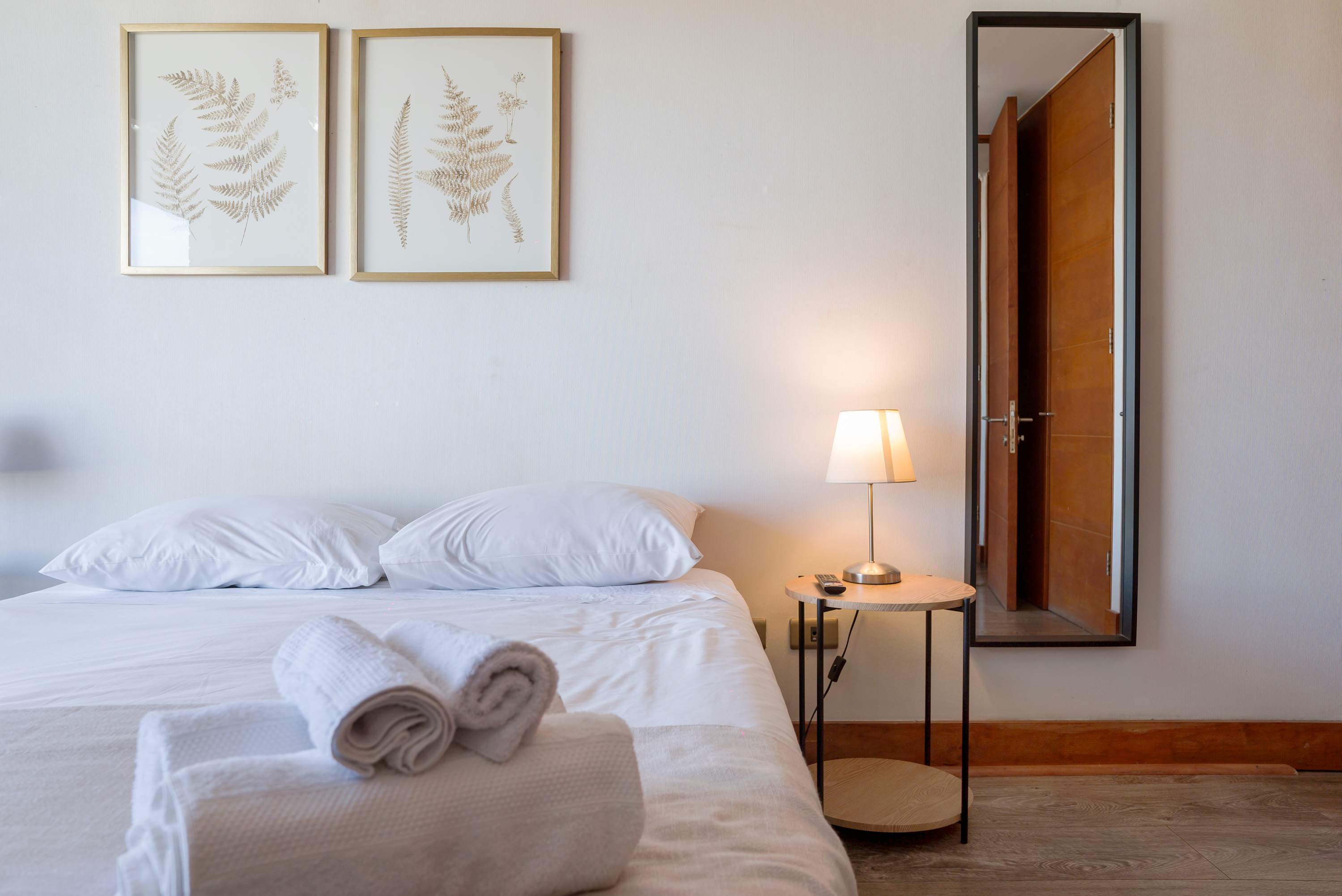 Relax in this serene bedroom with elegant decor and cozy bedding, perfect for unwinding after a day of adventures.