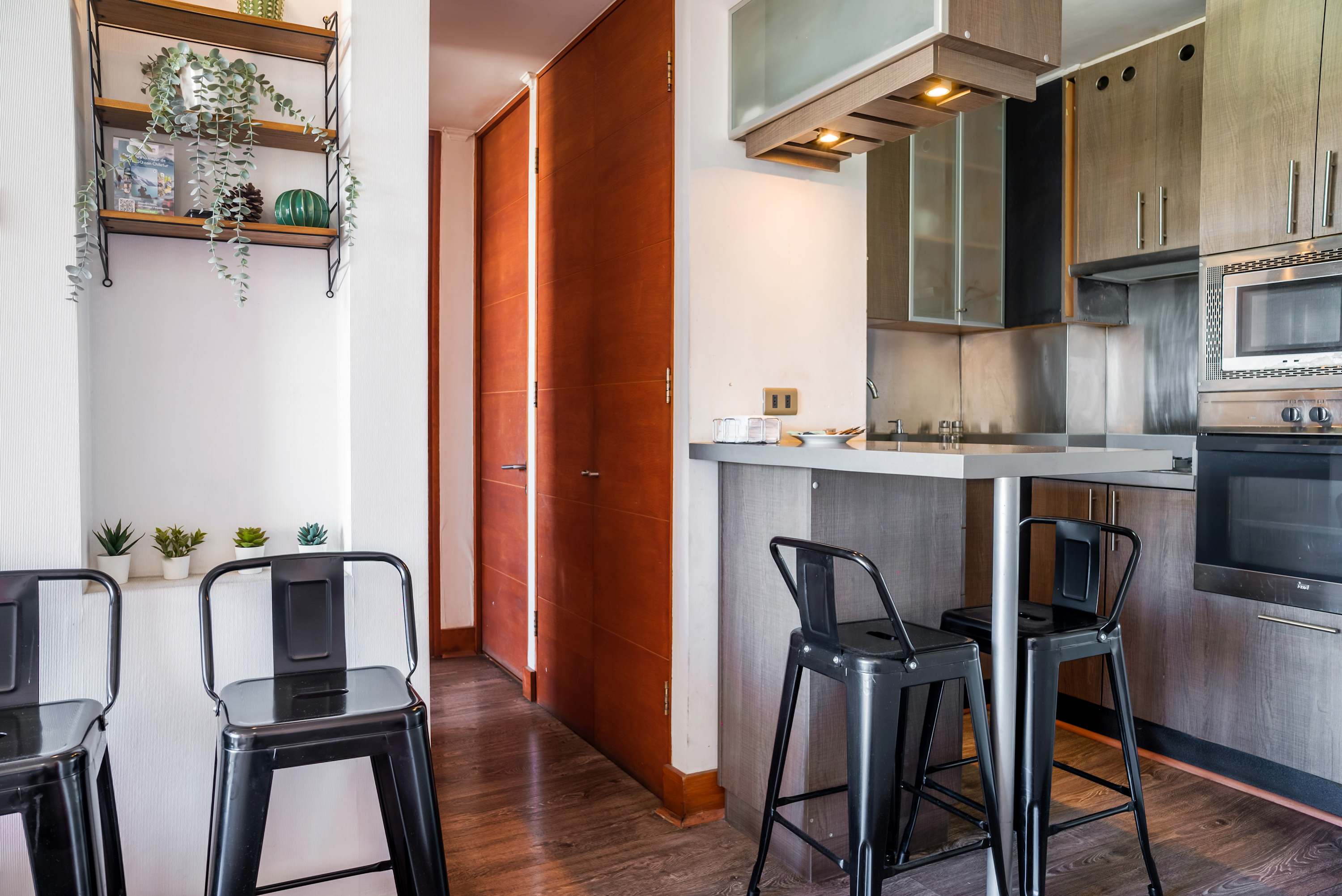 Modern kitchen with sleek appliances and cozy bar seating, ideal for casual dining and entertaining.