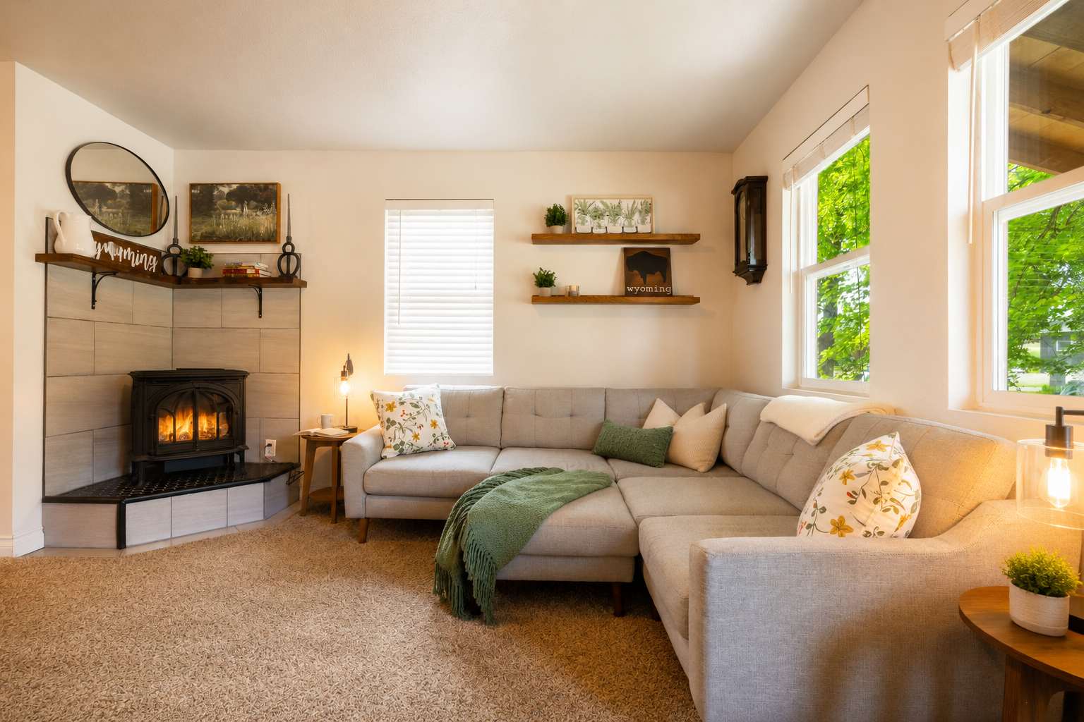 Cozy living room at The Maple with a sectional sofa, gas fireplace, and large windows — Sheridan, Wyoming
