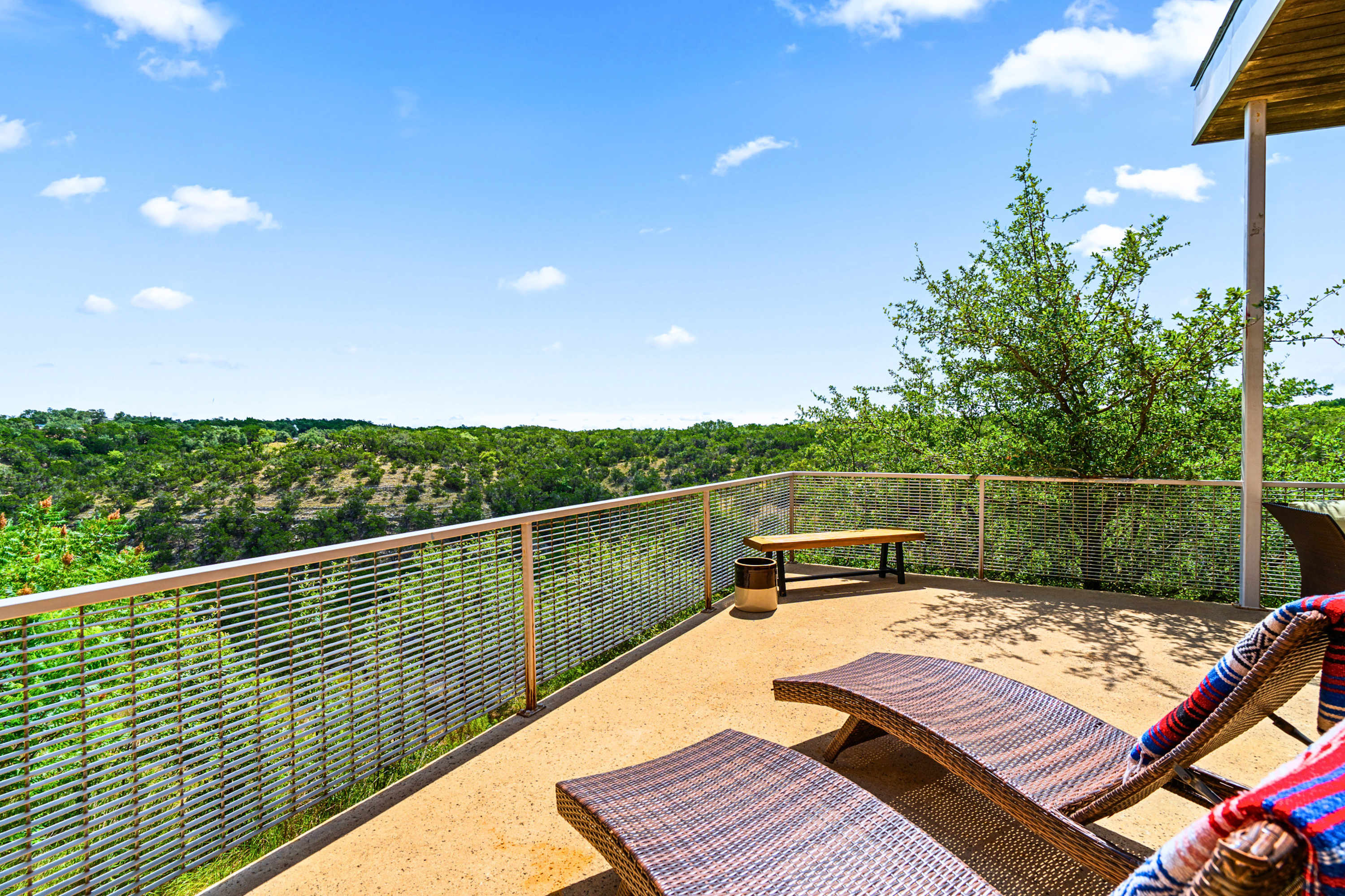 BBQ-ready outdoor lounge with sweeping hillside views