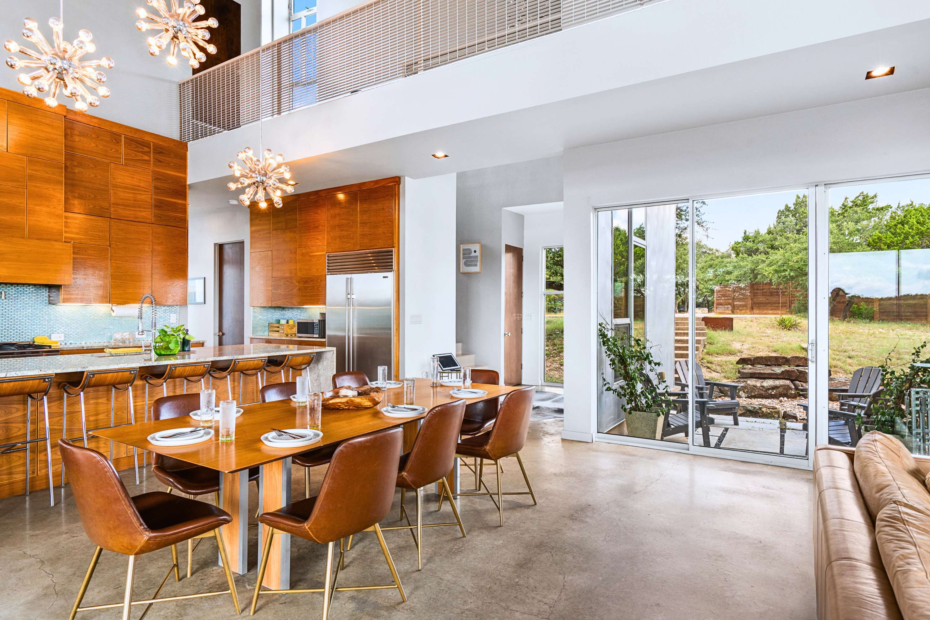 Cook and connect in this modern open-concept kitchen, bar, and dining