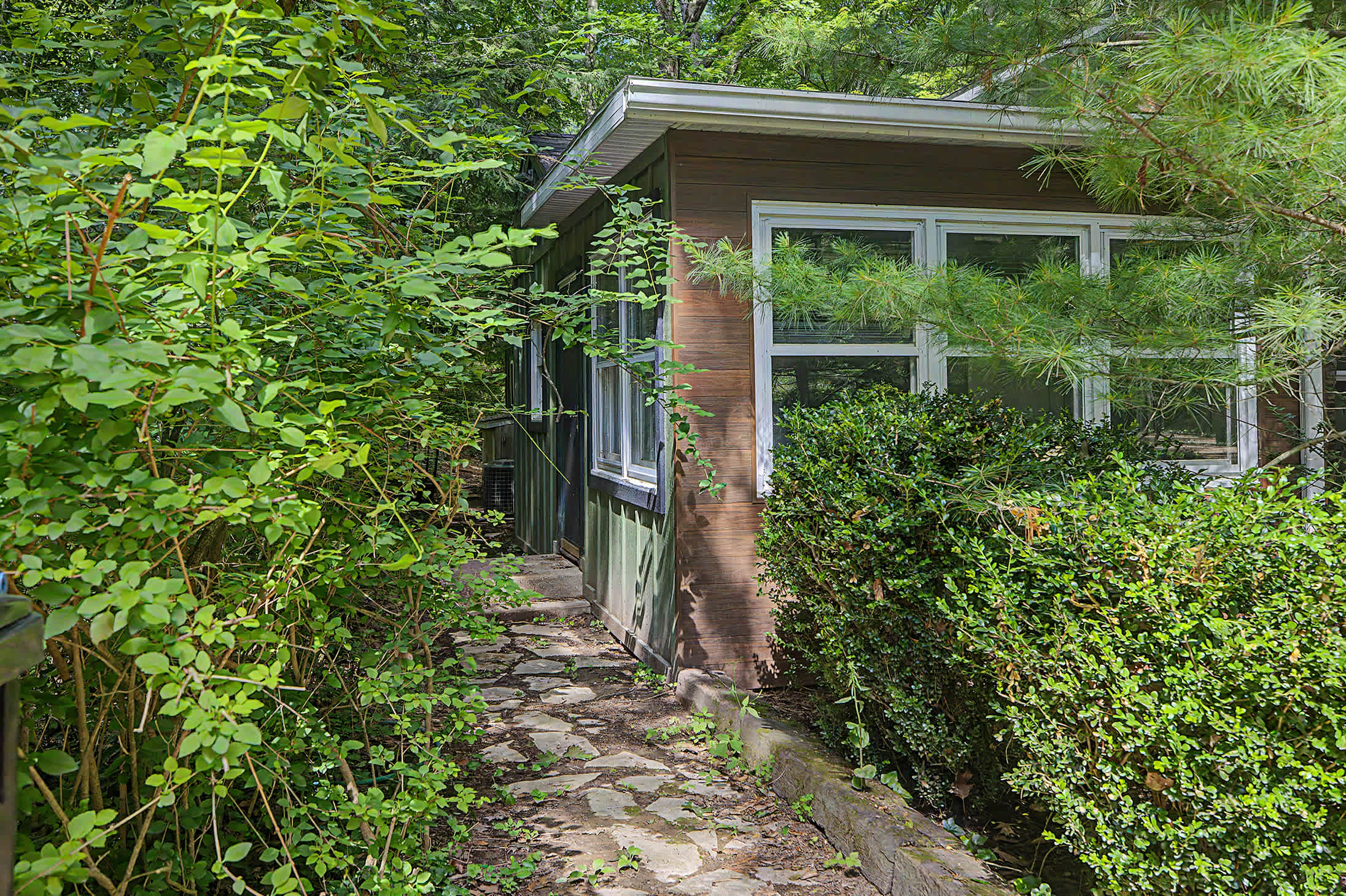 A quiet wooded setting adds privacy while keeping Harbert attractions nearby.