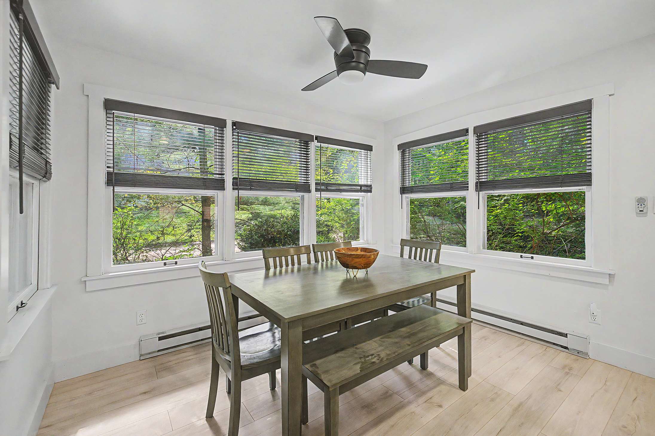 Window lined dining space keeps everyone together at mealtime.
