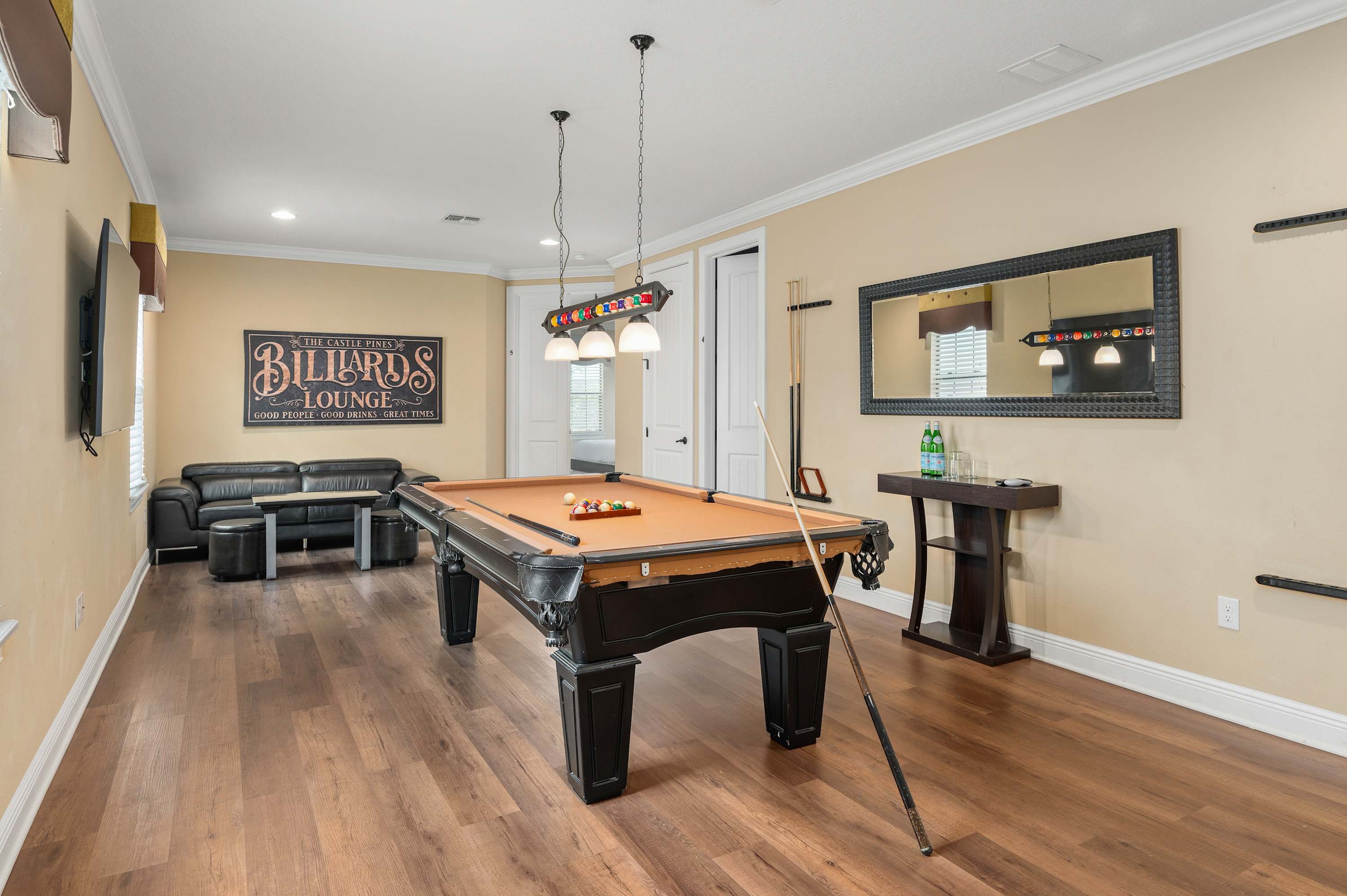 Enjoy a game of pool in this inviting lounge with modern lighting and comfortable seating.