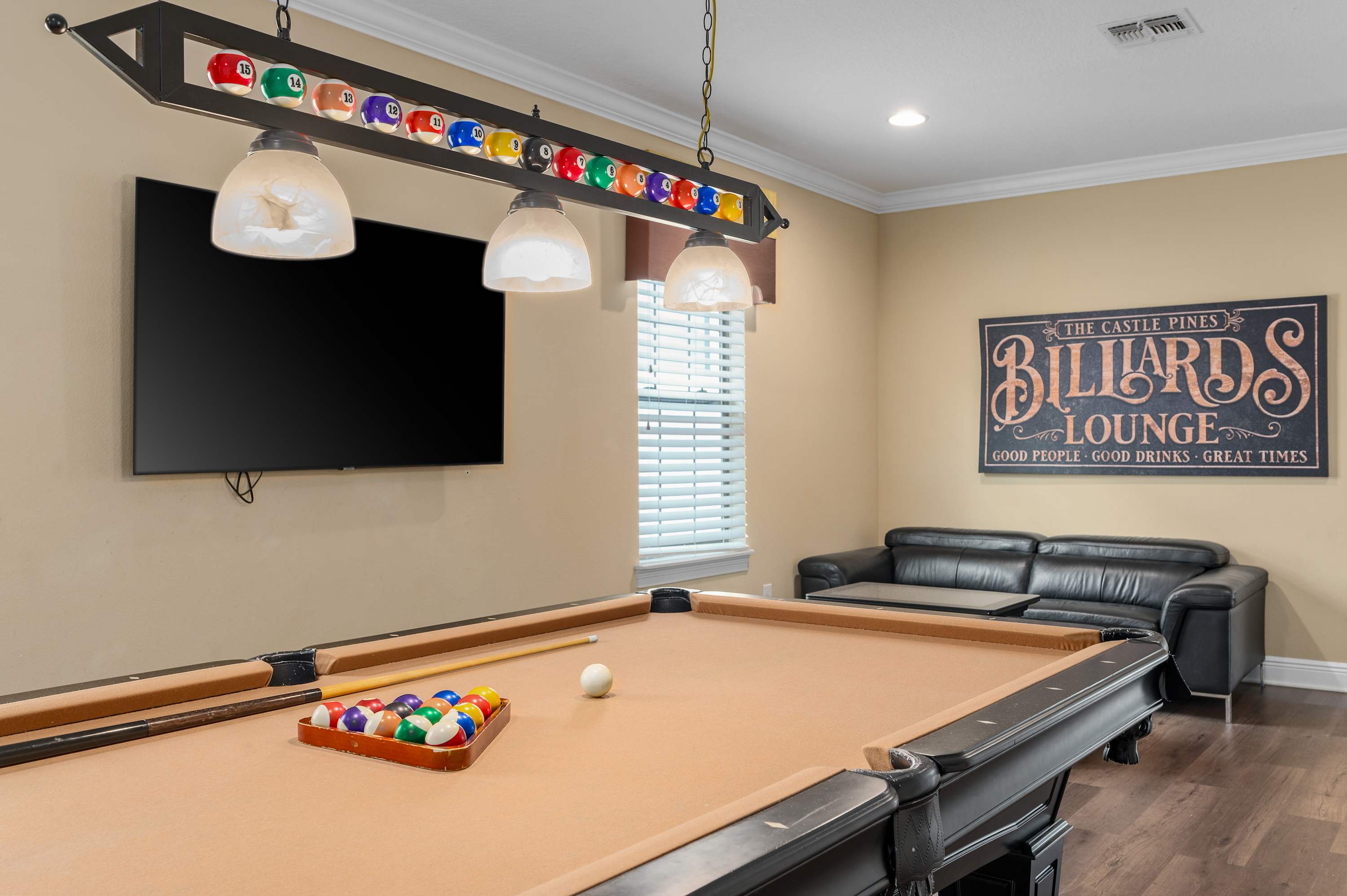 Enjoy a game of pool in this inviting billiards lounge with comfortable seating and a large TV.