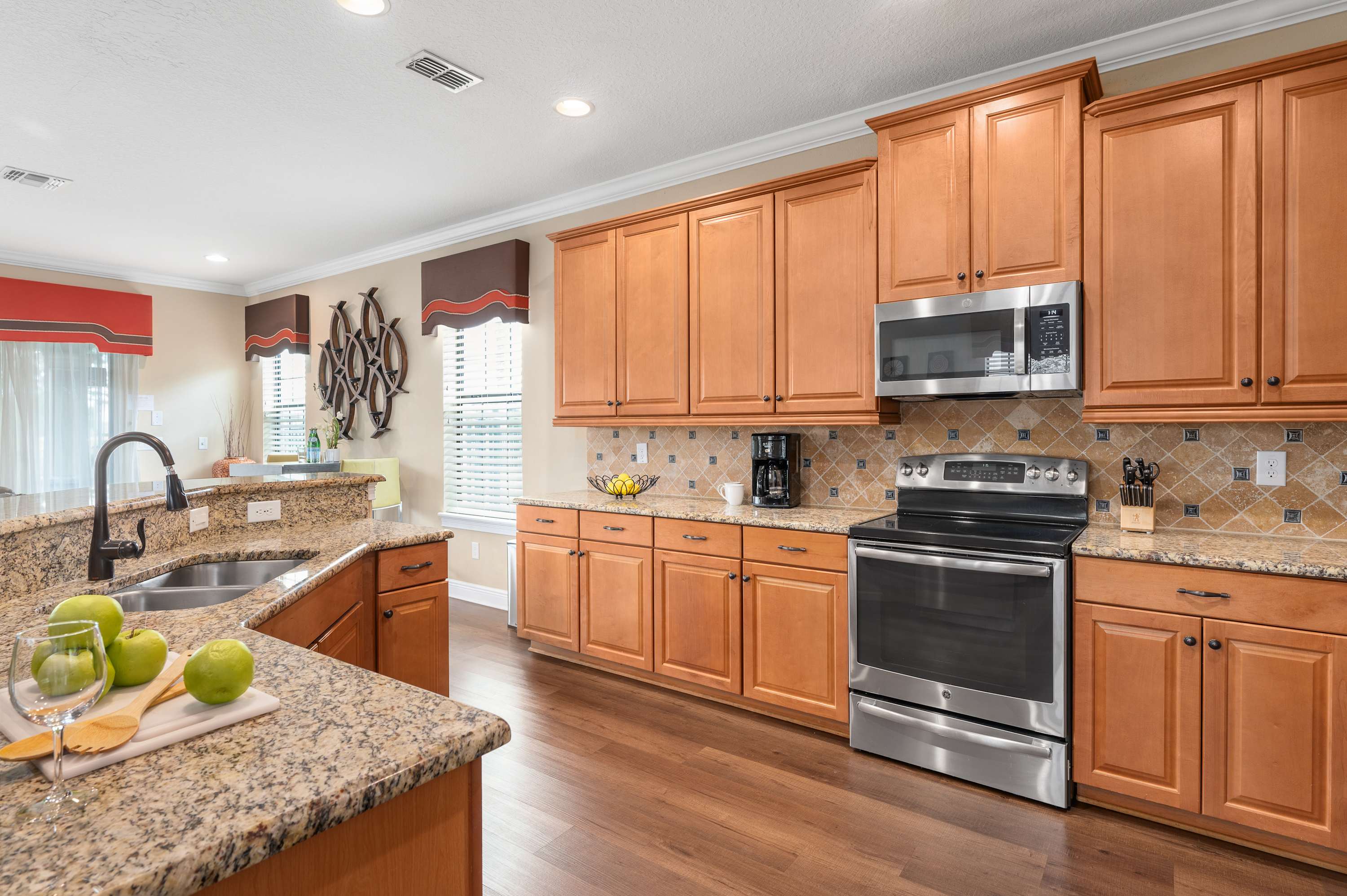 Spacious kitchen with granite countertops and stainless steel appliances.