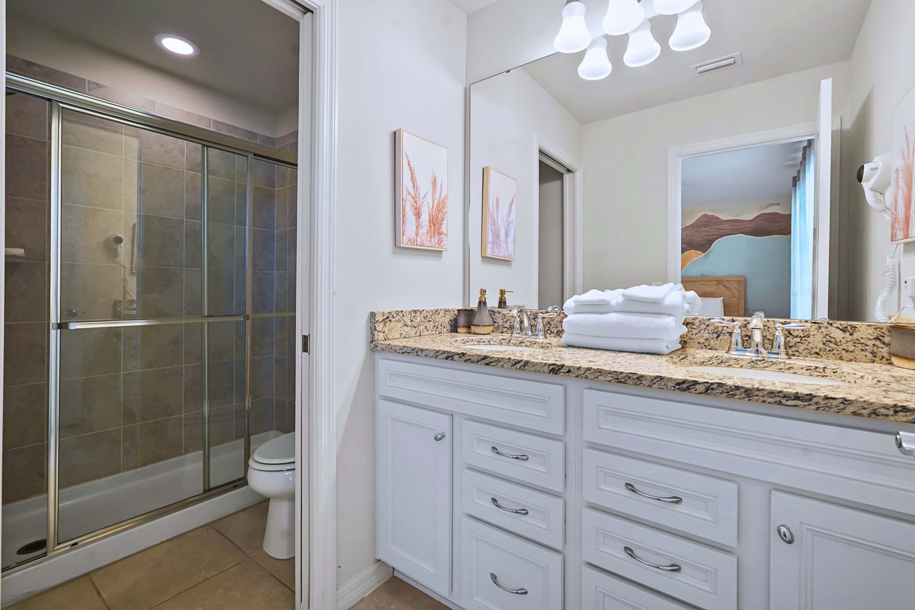 Enjoy a clean bathroom layout complete with a spacious glass-enclosed walk-in shower.