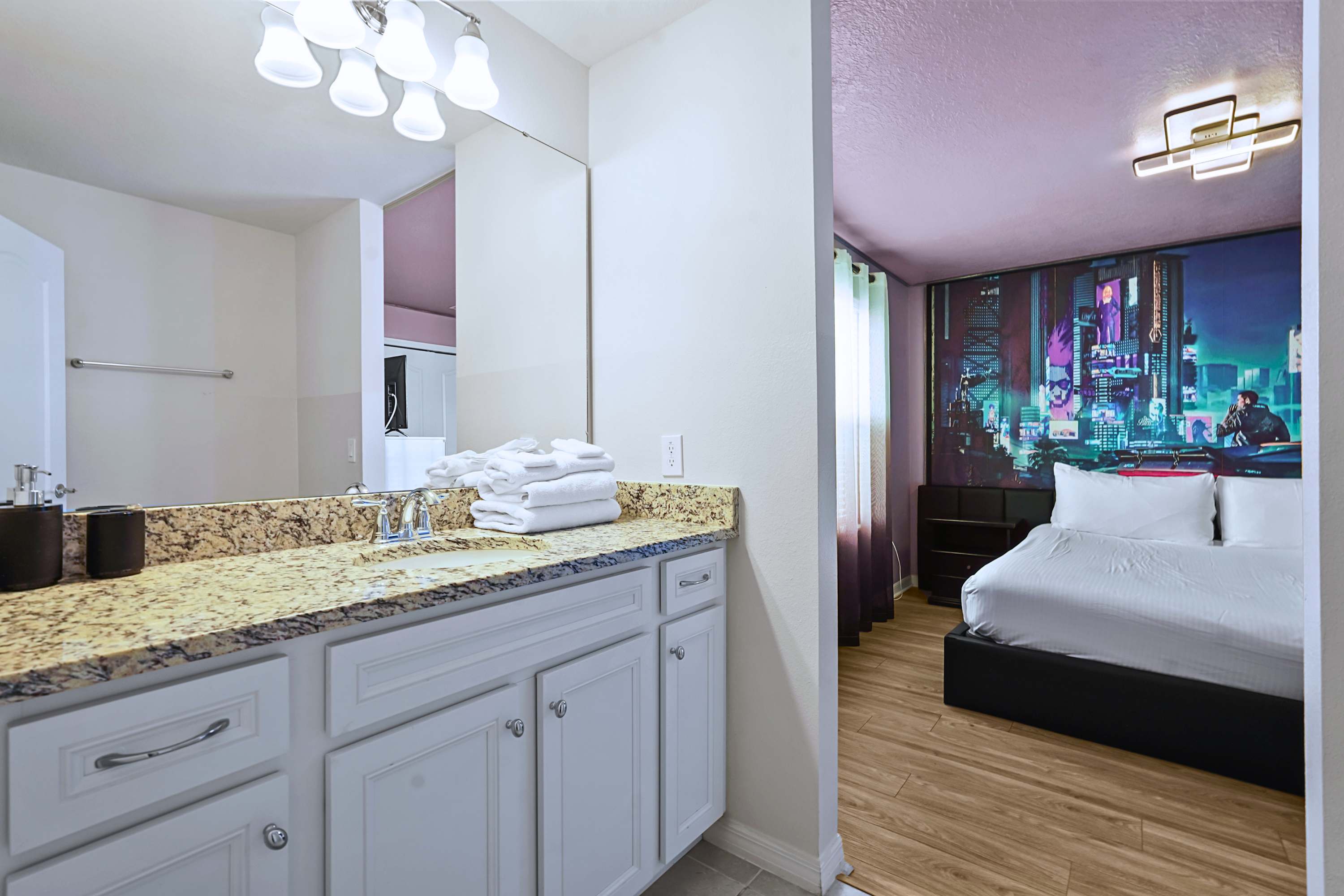 Clean and highly functional layout with a massive mirror and bright, premium vanity lighting.