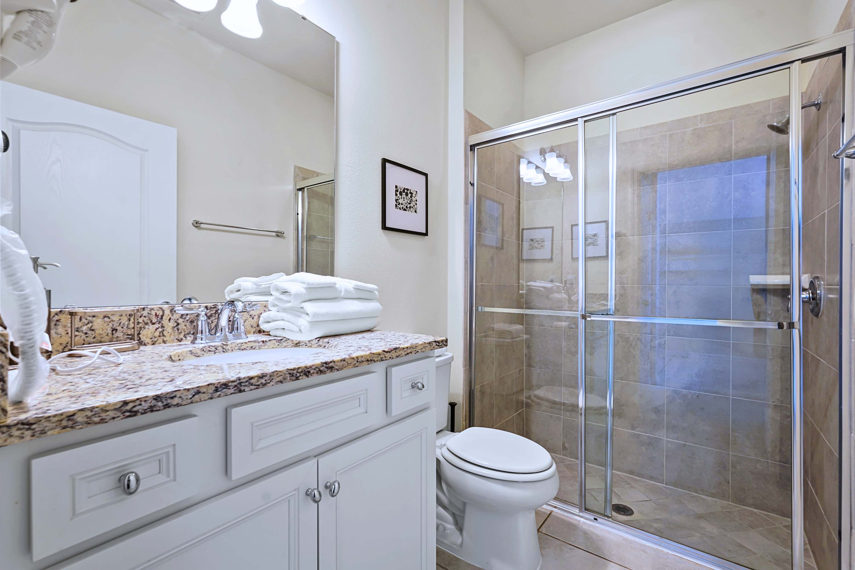 Premium granite counters and a massive glass walk-in shower make morning prep a breeze.