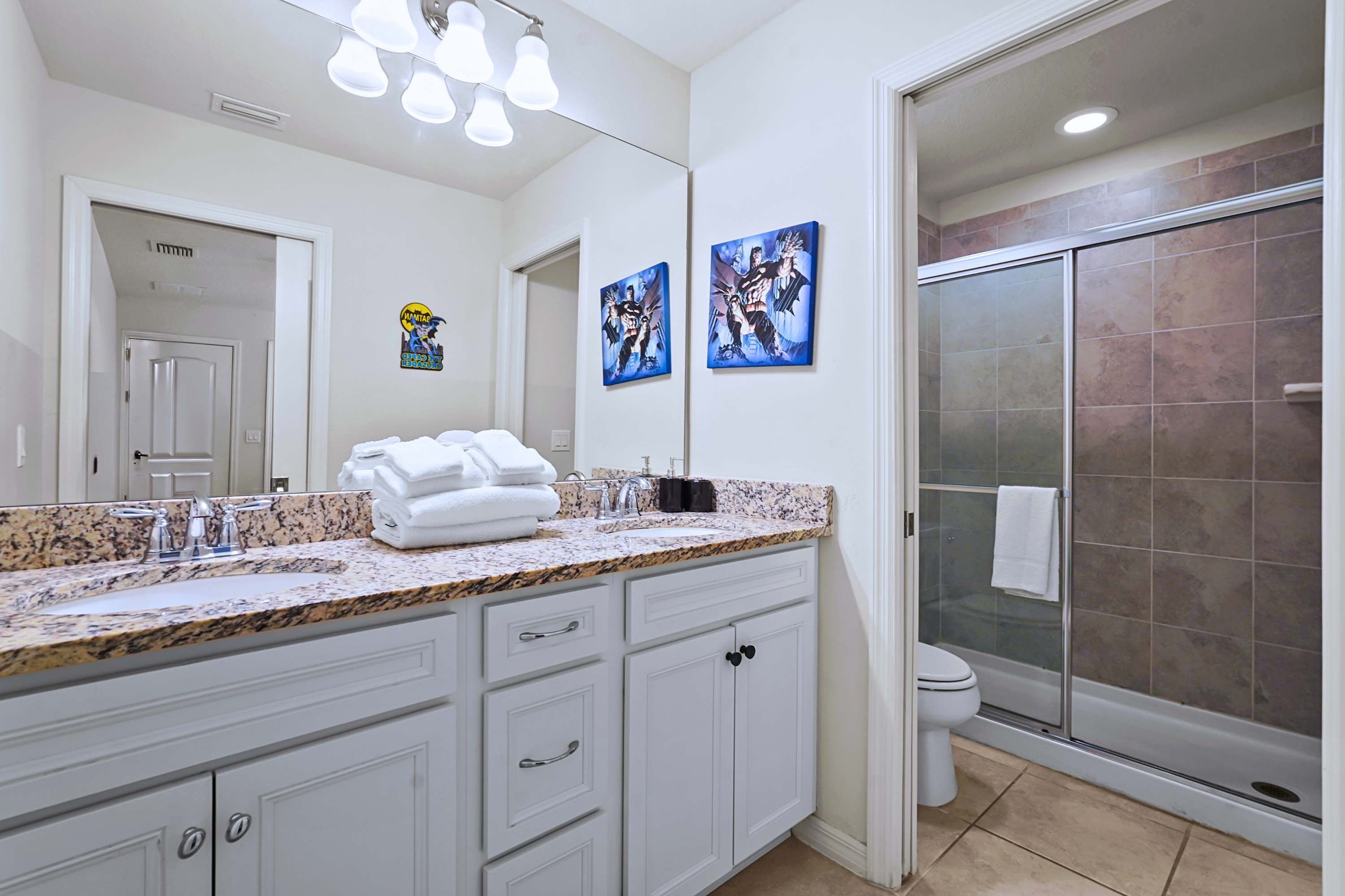 Stone finishes and bright vanity lighting offer a true relaxing atmosphere.
