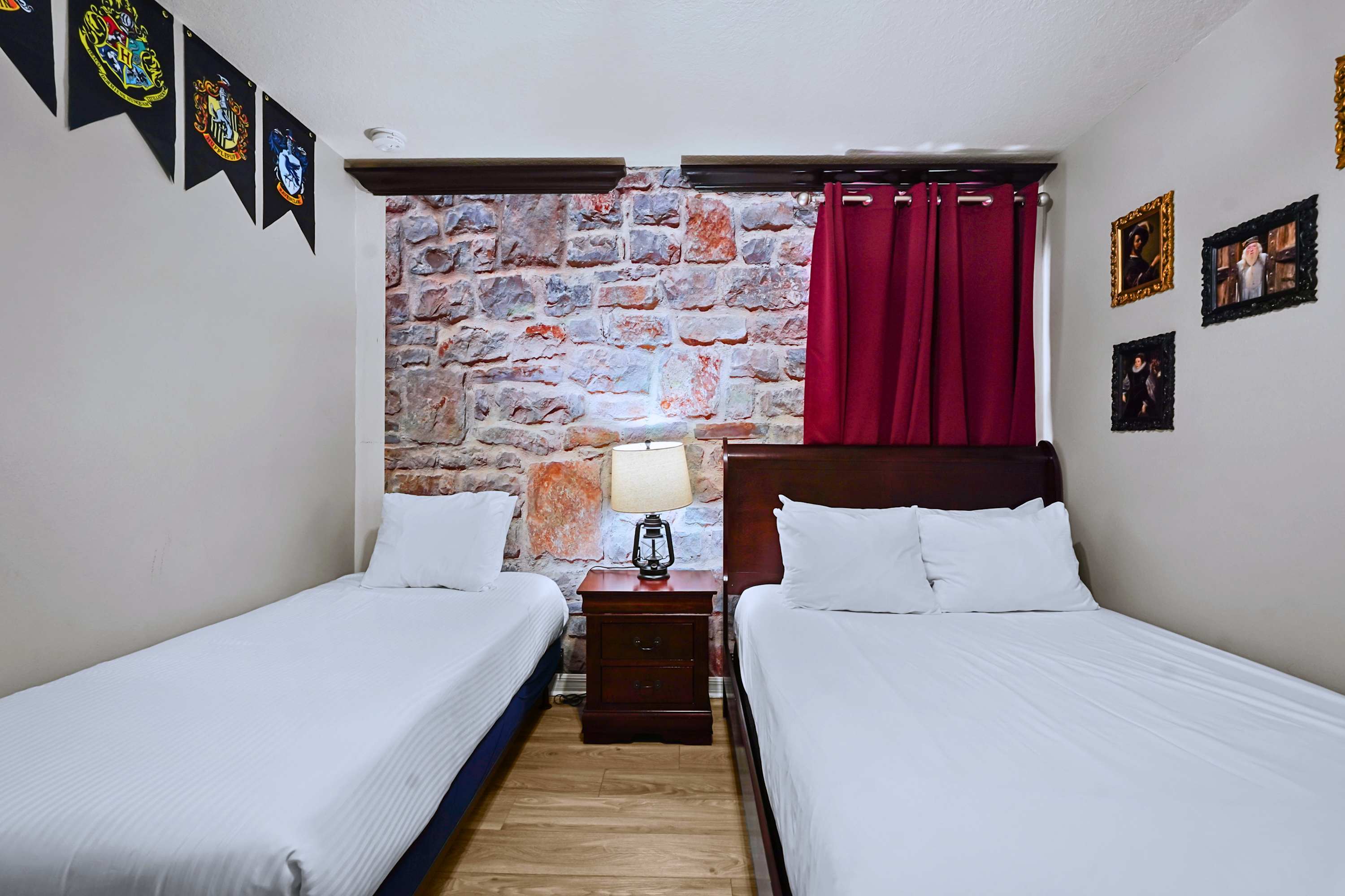 Fun rustic brick accent walls with a cozy full-size and twin bed.