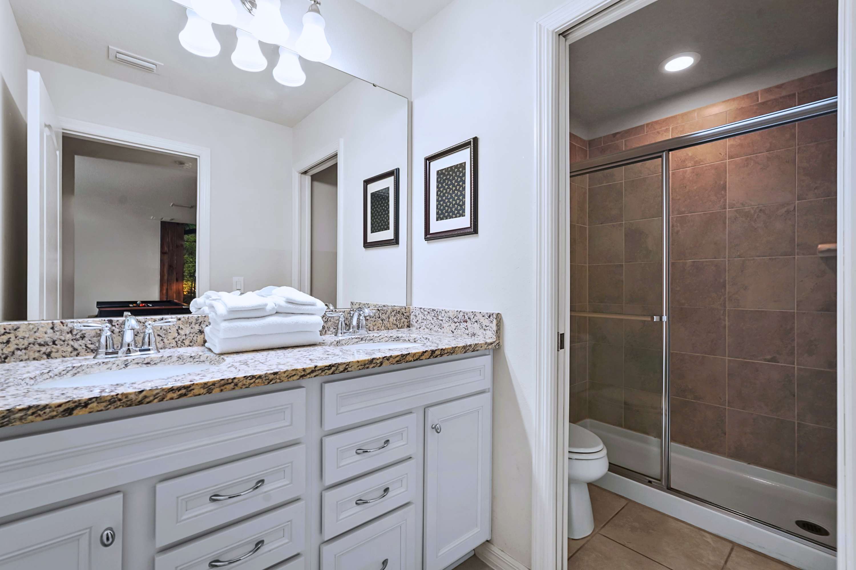 Sparkling clean bathroom with a large vanity and ample space to prepare for the day.