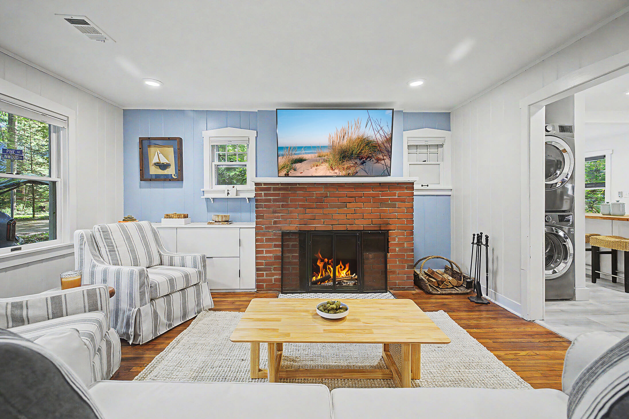 Main living area with a wood burning fireplace and large TV keeps downtime simple between beach trips and day outings.