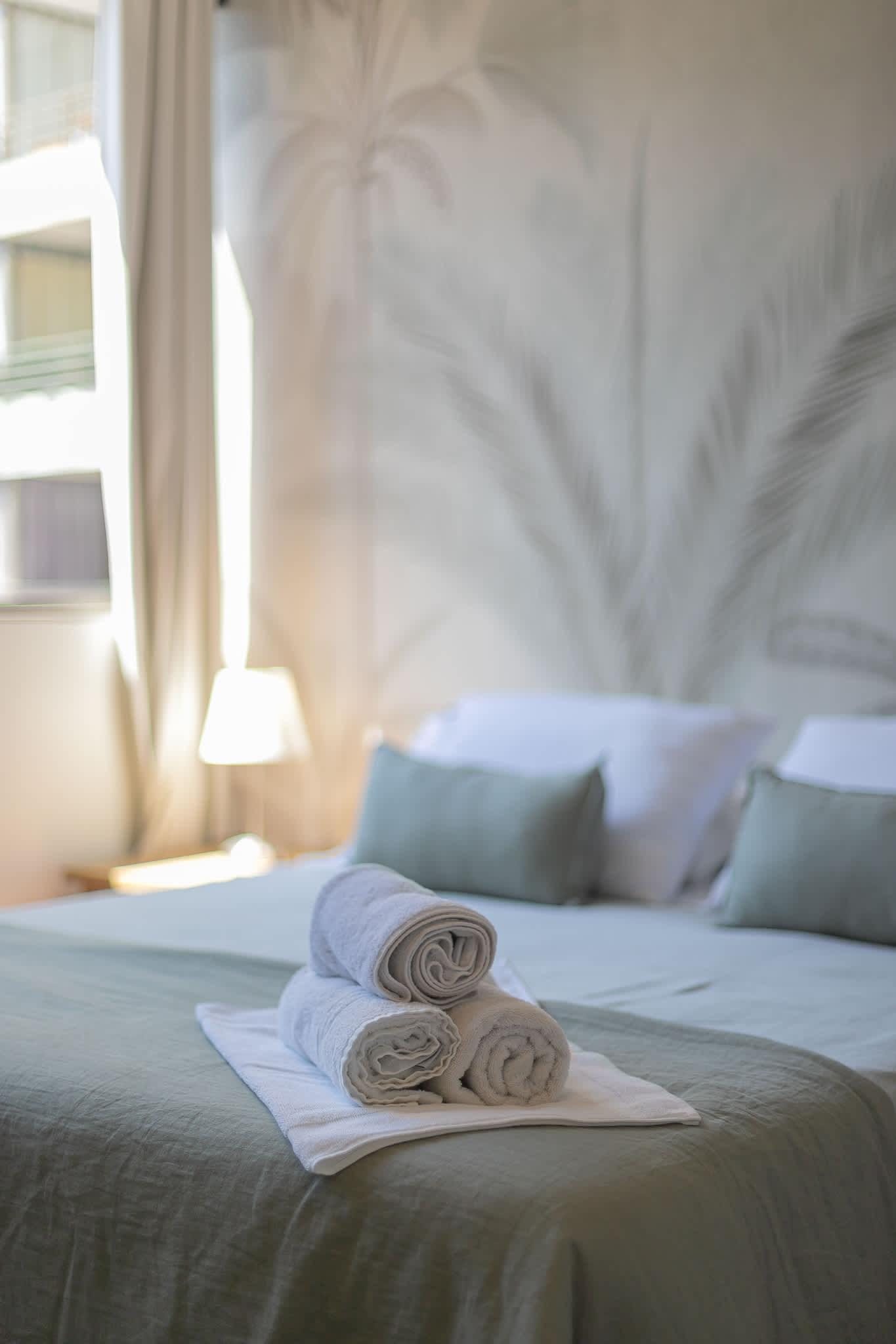 Relax in this serene bedroom with soft natural light and cozy bedding, perfect for unwinding after a day of exploring.