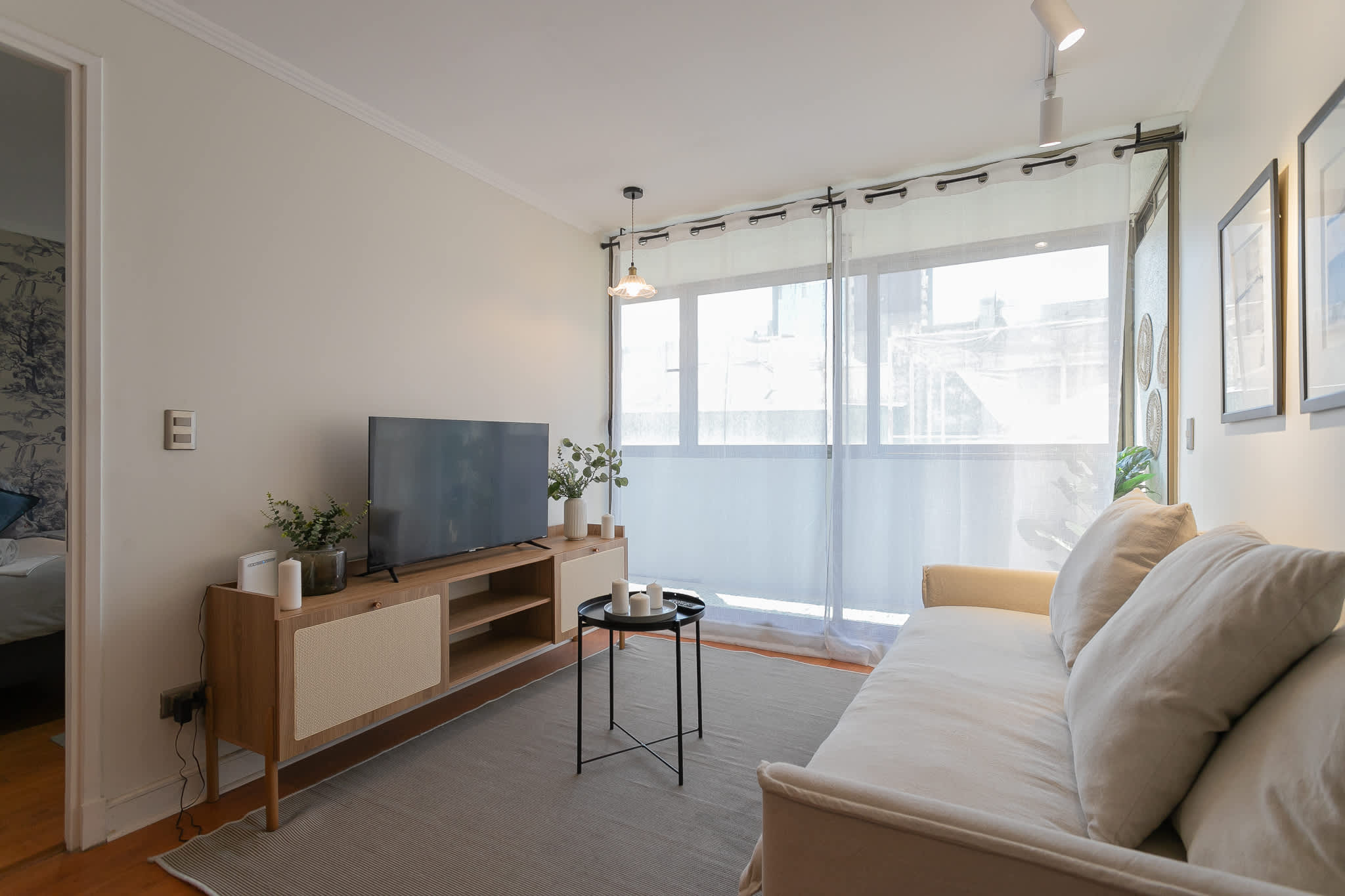 Bright and cozy living room with modern decor and ample natural light, perfect for relaxation.