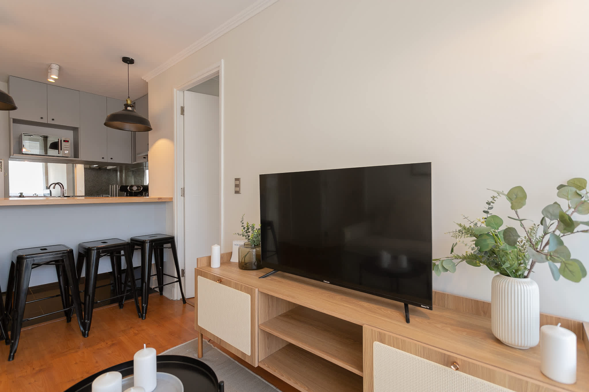 Relax in this cozy living area with a large TV and stylish decor, perfect for unwinding after exploring the city.