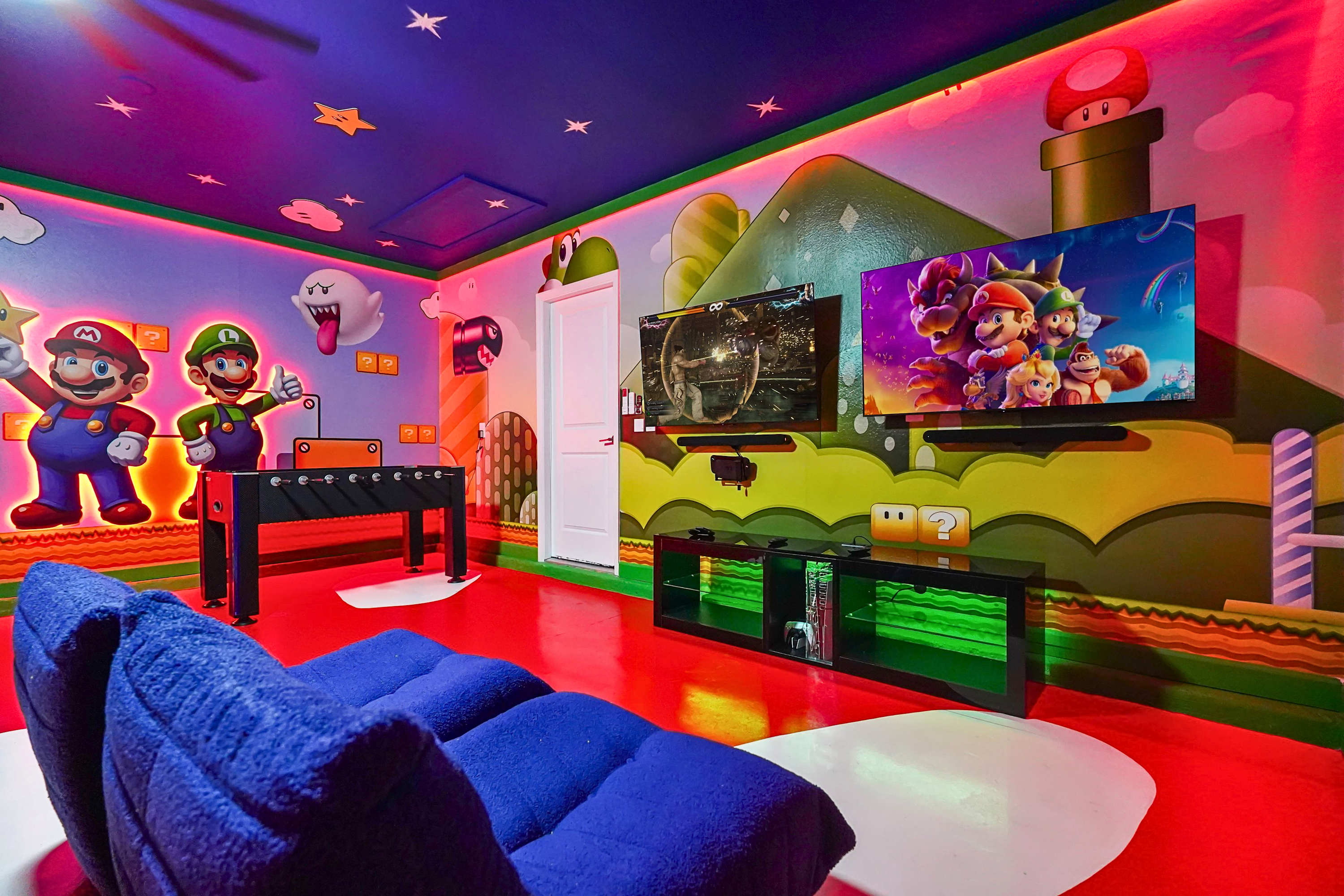 Enjoy family game nights in the Mario and Luigi themed game room featuring arcade, consoles, foosball, and lounge seating