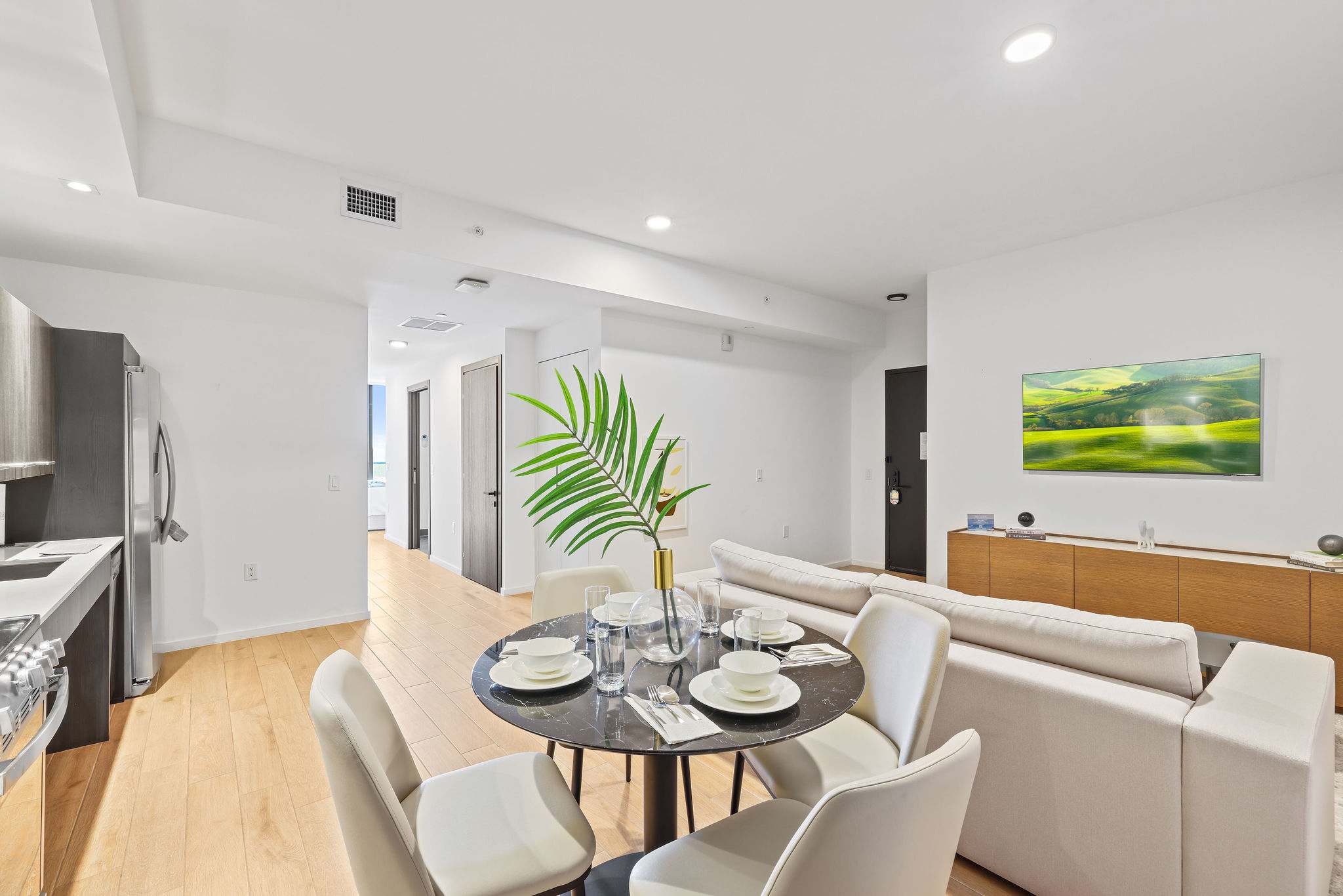 Experience modern comfort in this stylish studio with a sleek kitchen, cozy seating, and dining area perfect for relaxing or entertaining.
