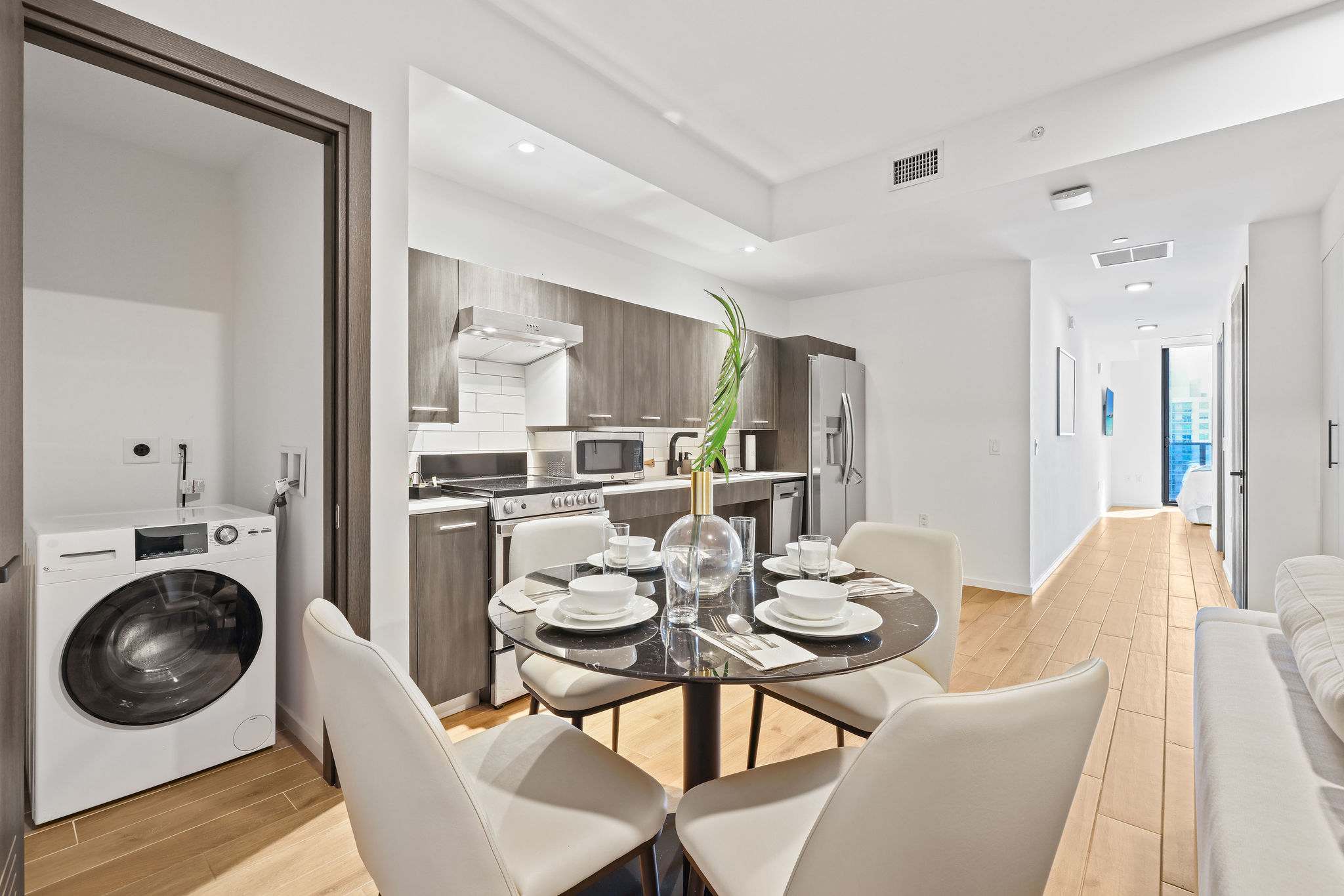 Enjoy a sleek, modern kitchen with all the essentials for a comfortable stay in this stylish studio apartment.