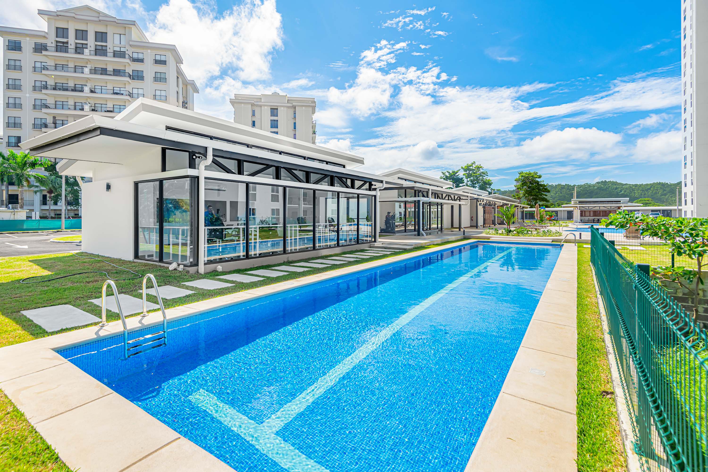 Outdoor Pool: Relax and soak up the sun at the sparkling resort-style pool, complete with lounge seating.