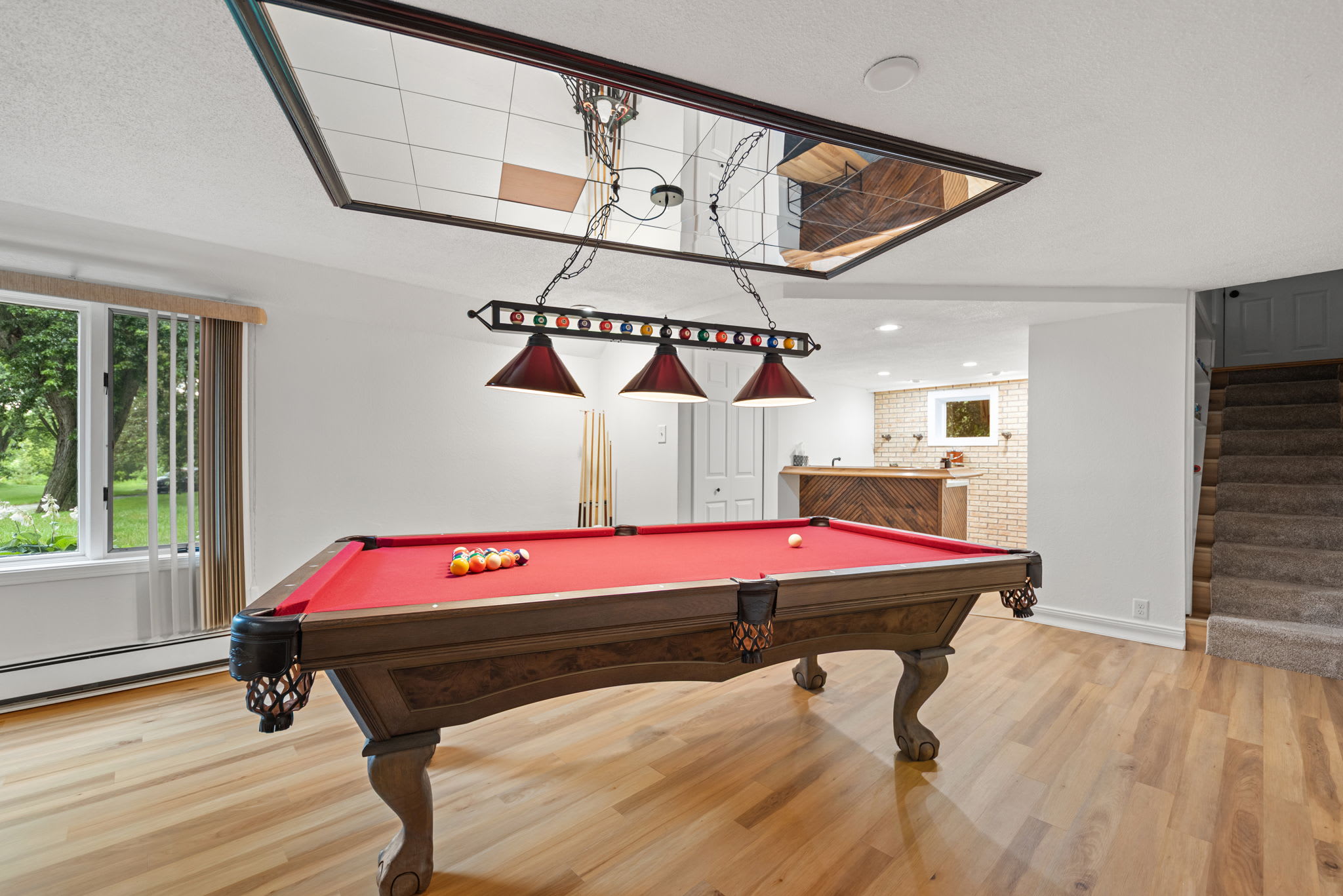 Billiards room beside the wet bar makes entertaining effortless.