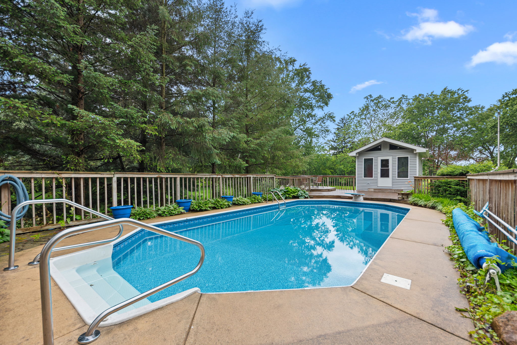 Private pool surrounded by trees for peaceful days at home.