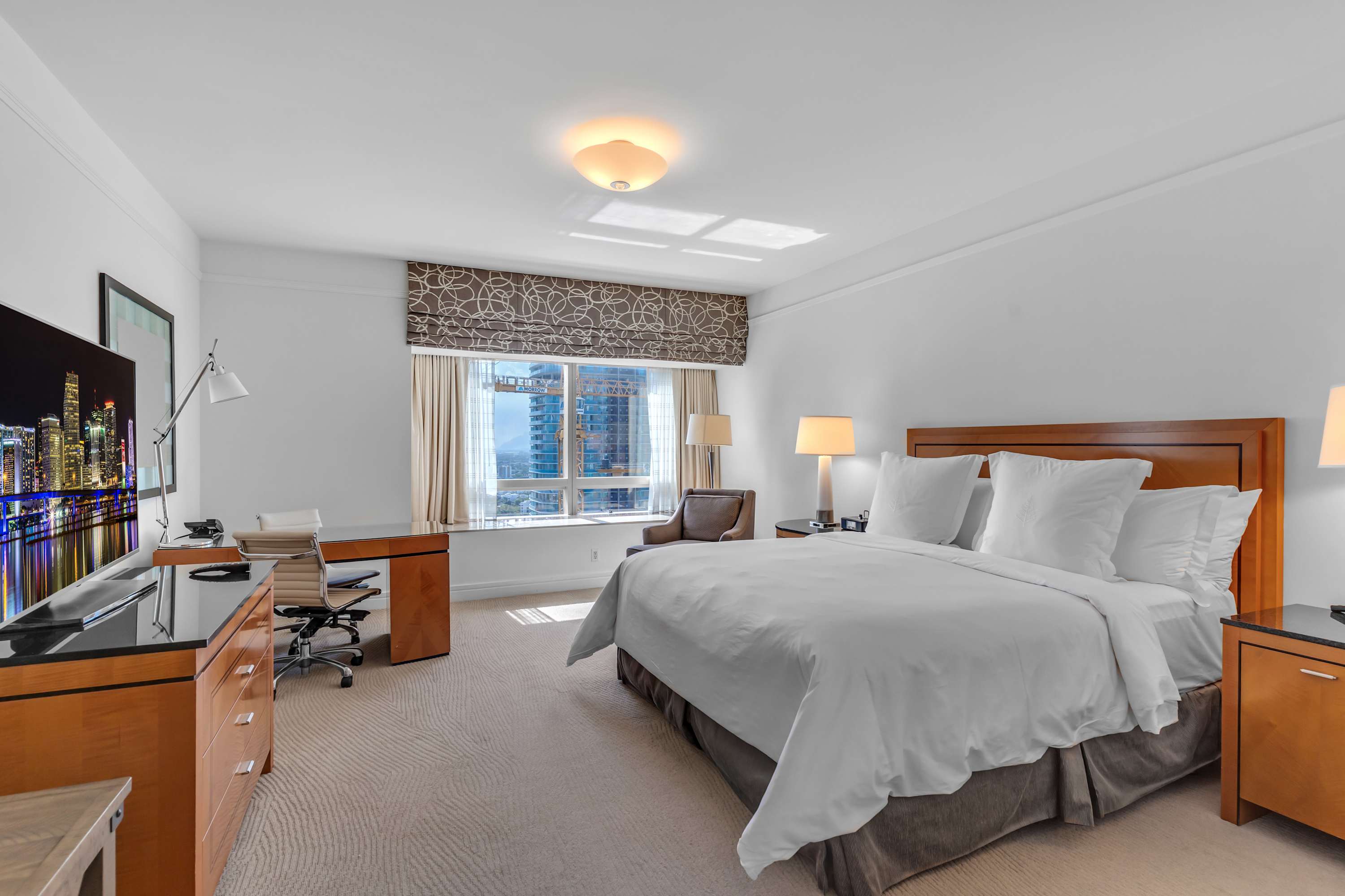 The primary king suite boasts a smart TV, private ensuite, & desk workspace​