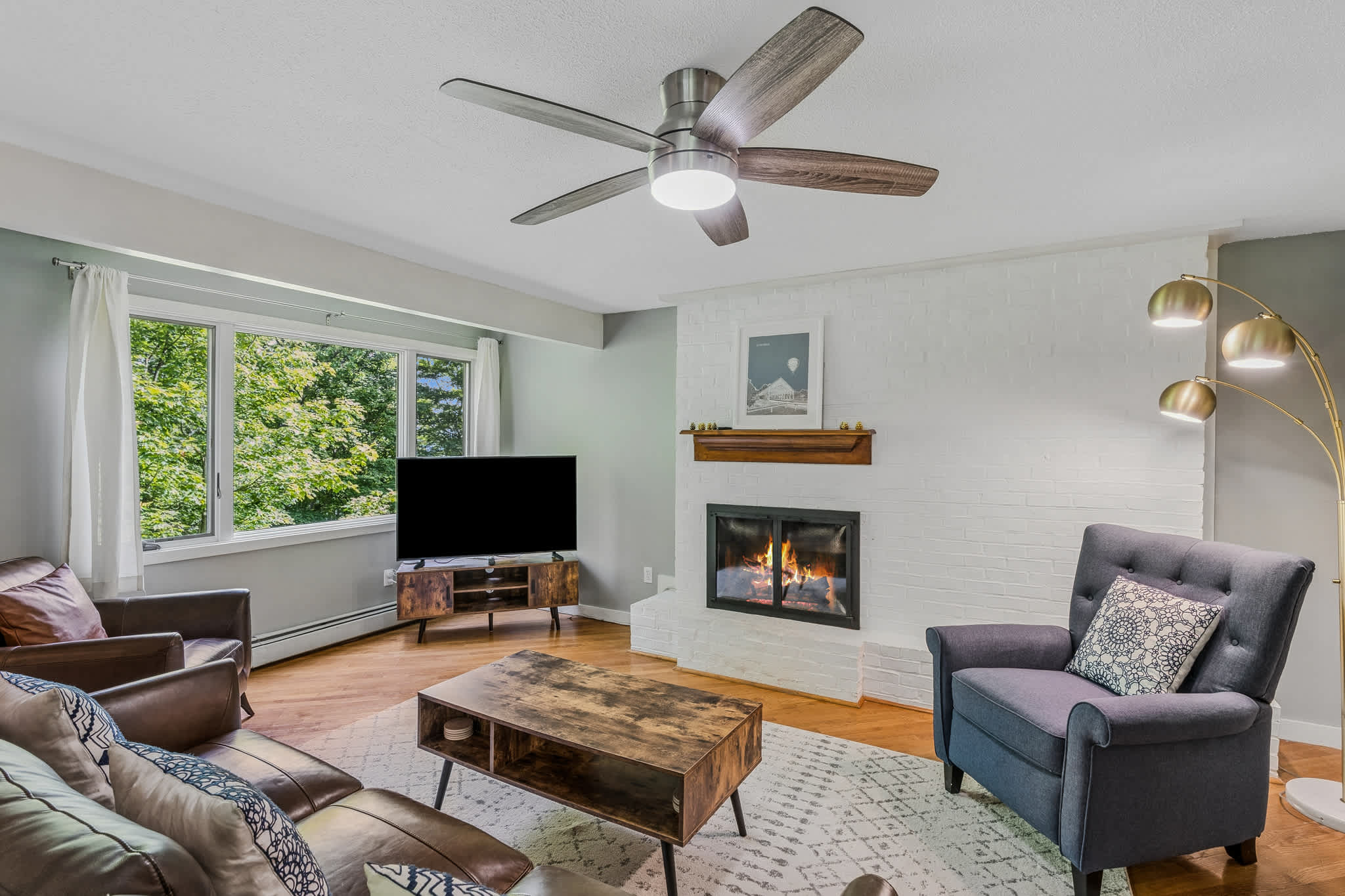 Living area with ceiling fan and gas fireplace