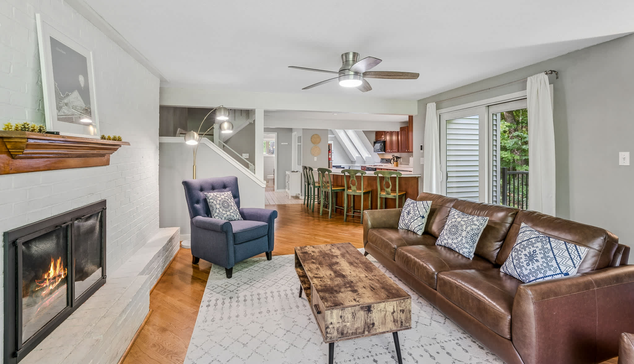 Open-concept living room with gas fireplace and hardwood floors