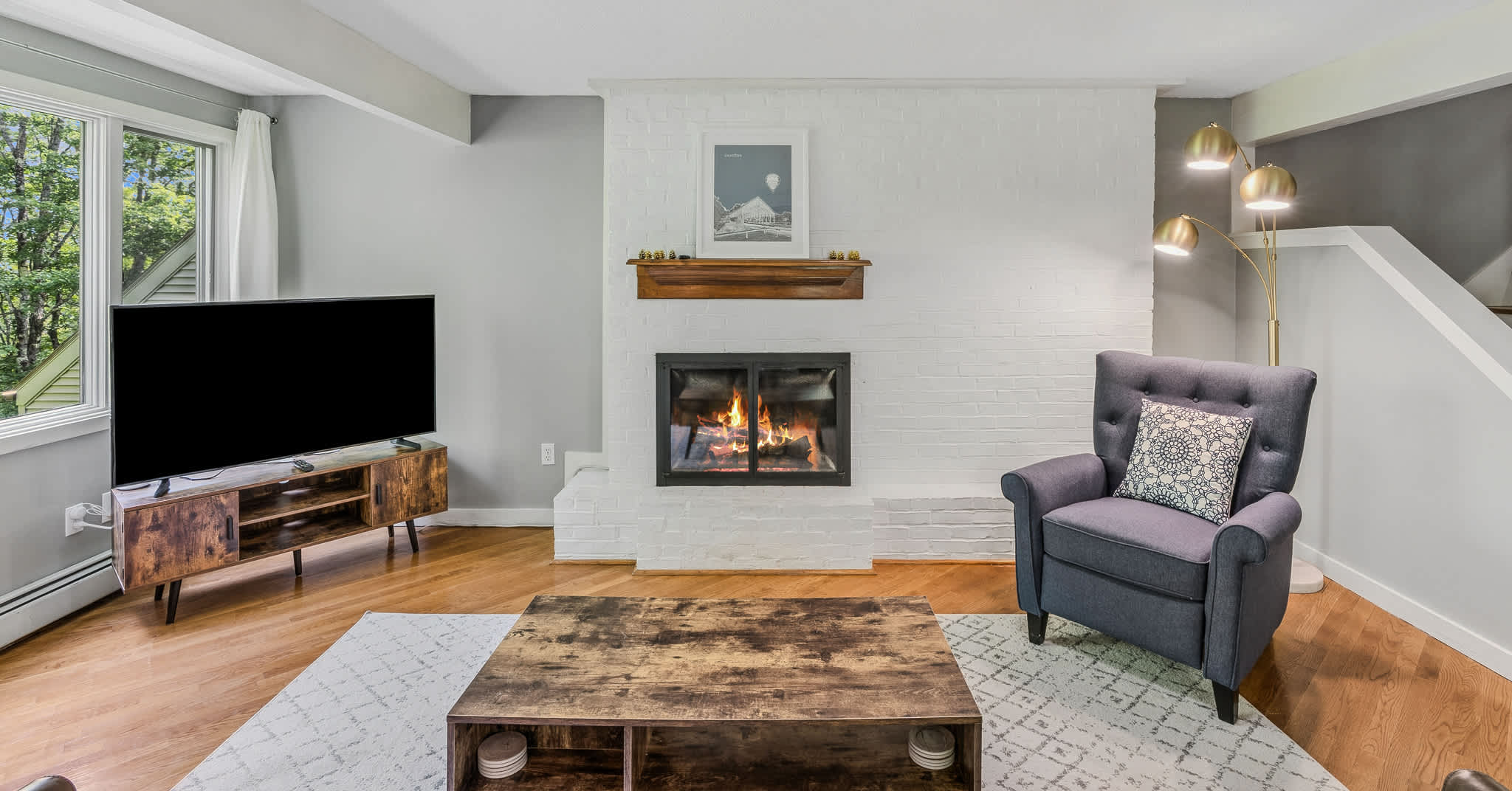 Cozy fireplace with smart TV and reading chair