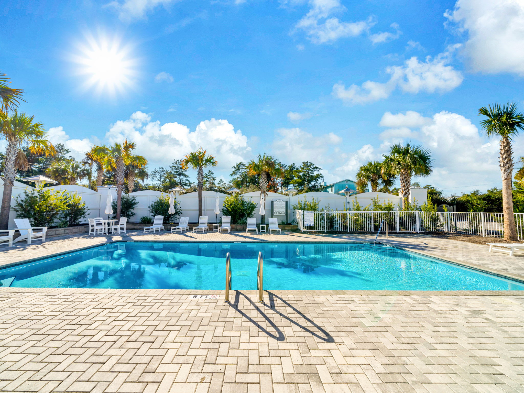Community pool with lounge chairs