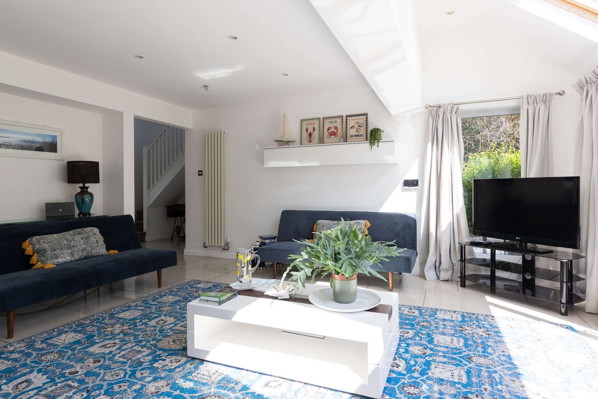 Relax in this beautiful holiday home living room, perfect for a modern coastal retreat.