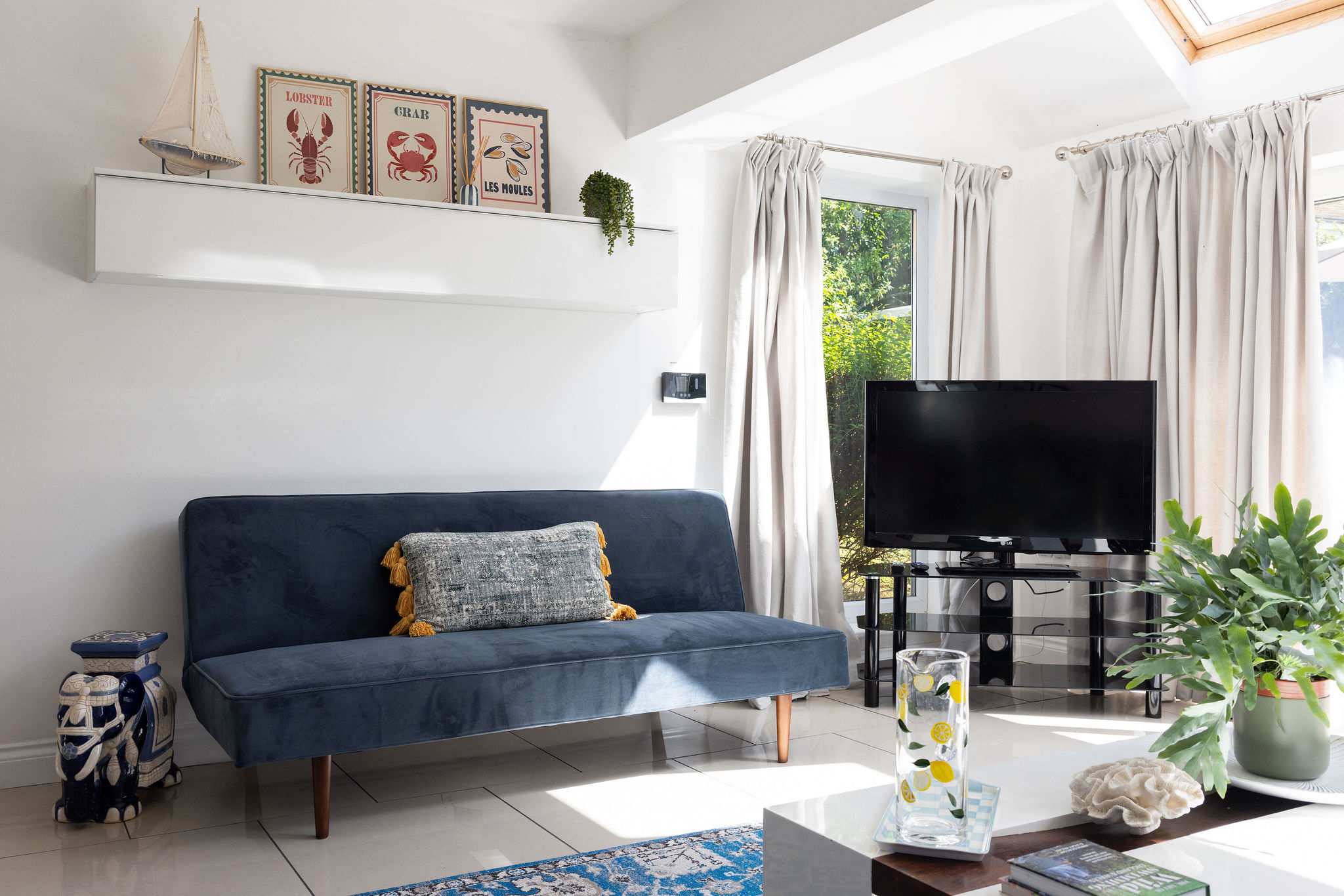 Relax on the comfortable sofa in this bright living space of our coastal retreat.