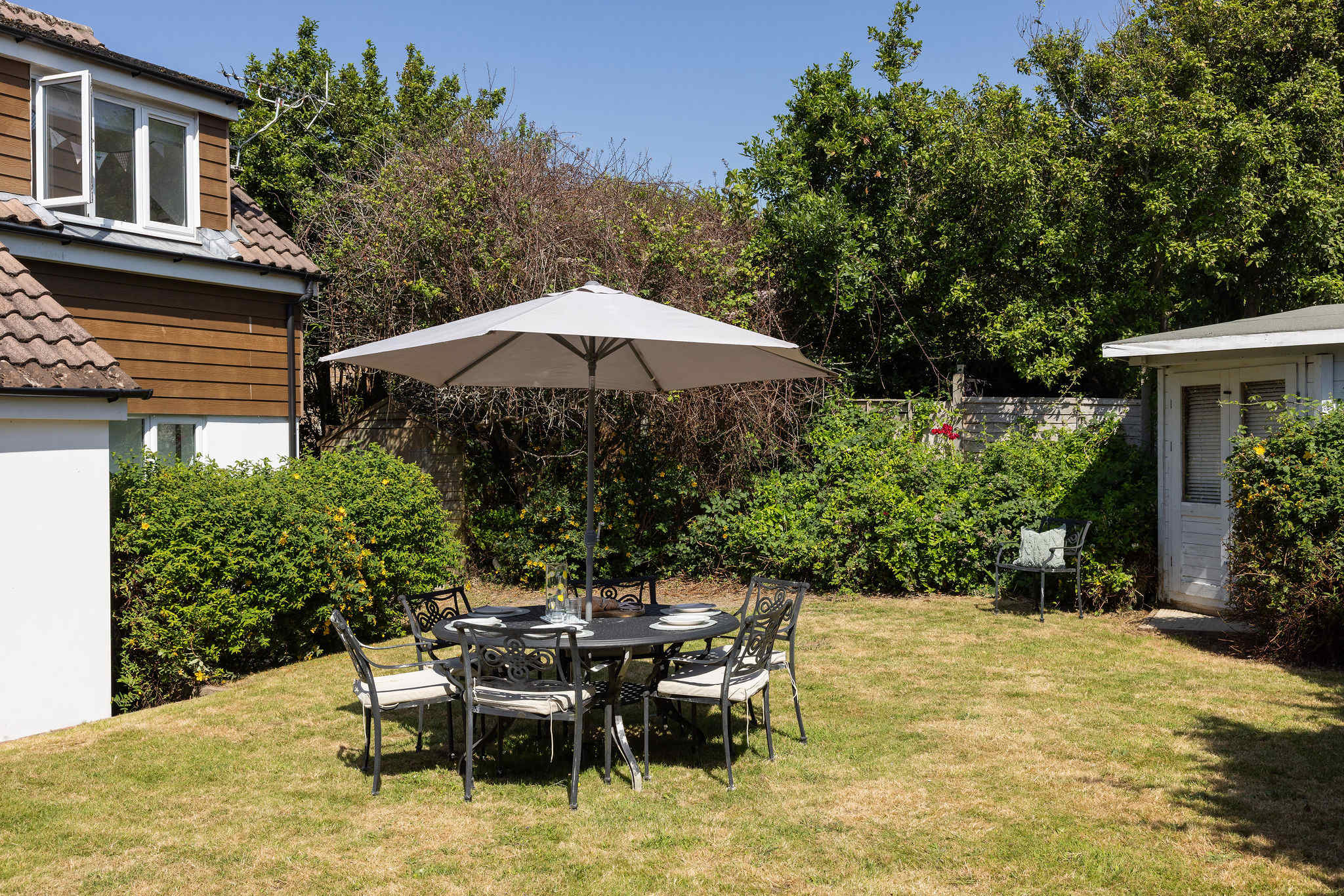 Enjoy outdoor dining in the spacious and sunny garden of this relaxing family getaway.