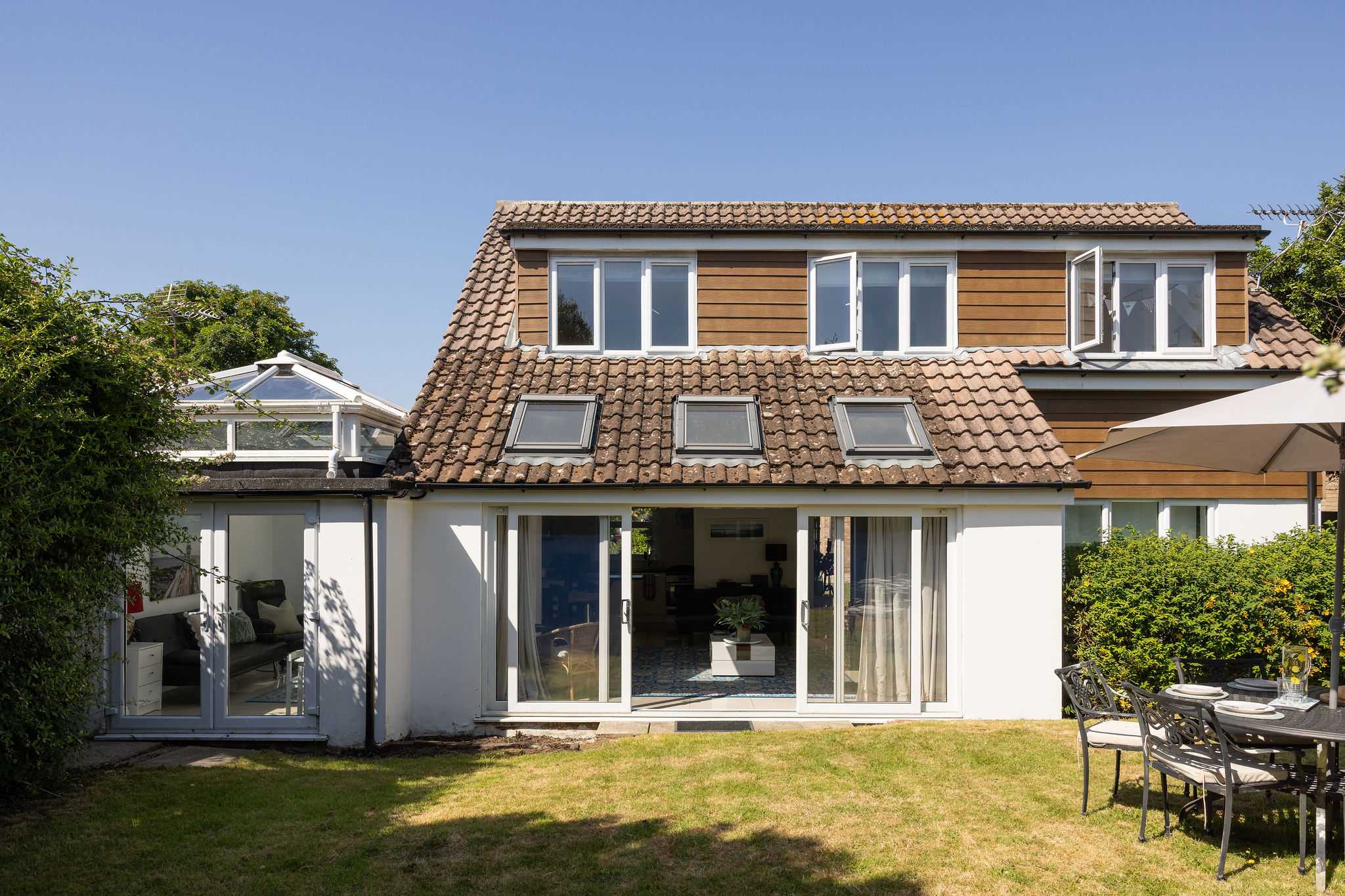 Admire the beautiful exterior of this spacious holiday home featuring a lovely private lawn.