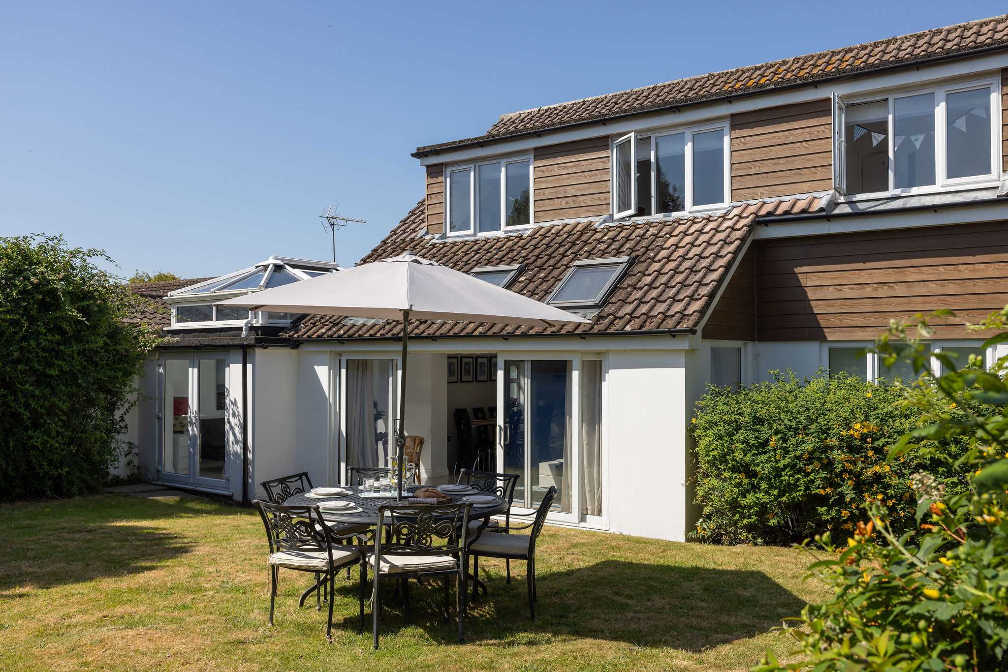 Enjoy sunny afternoons dining outdoors in the large garden of this wonderful family getaway.
